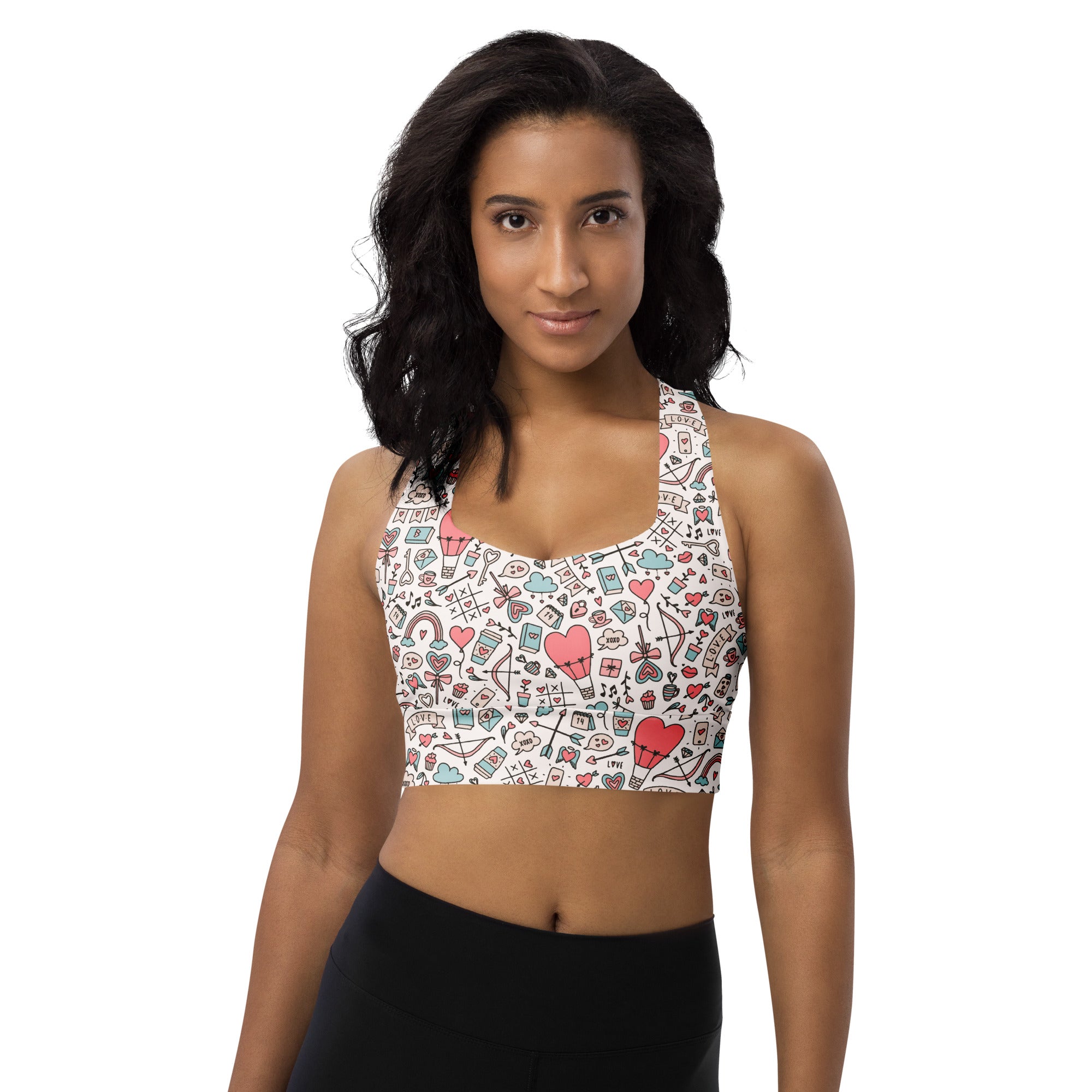 White women’s doodle heart longline sports bra with colorful hearts and bows, buttery soft recycled fabric, high support