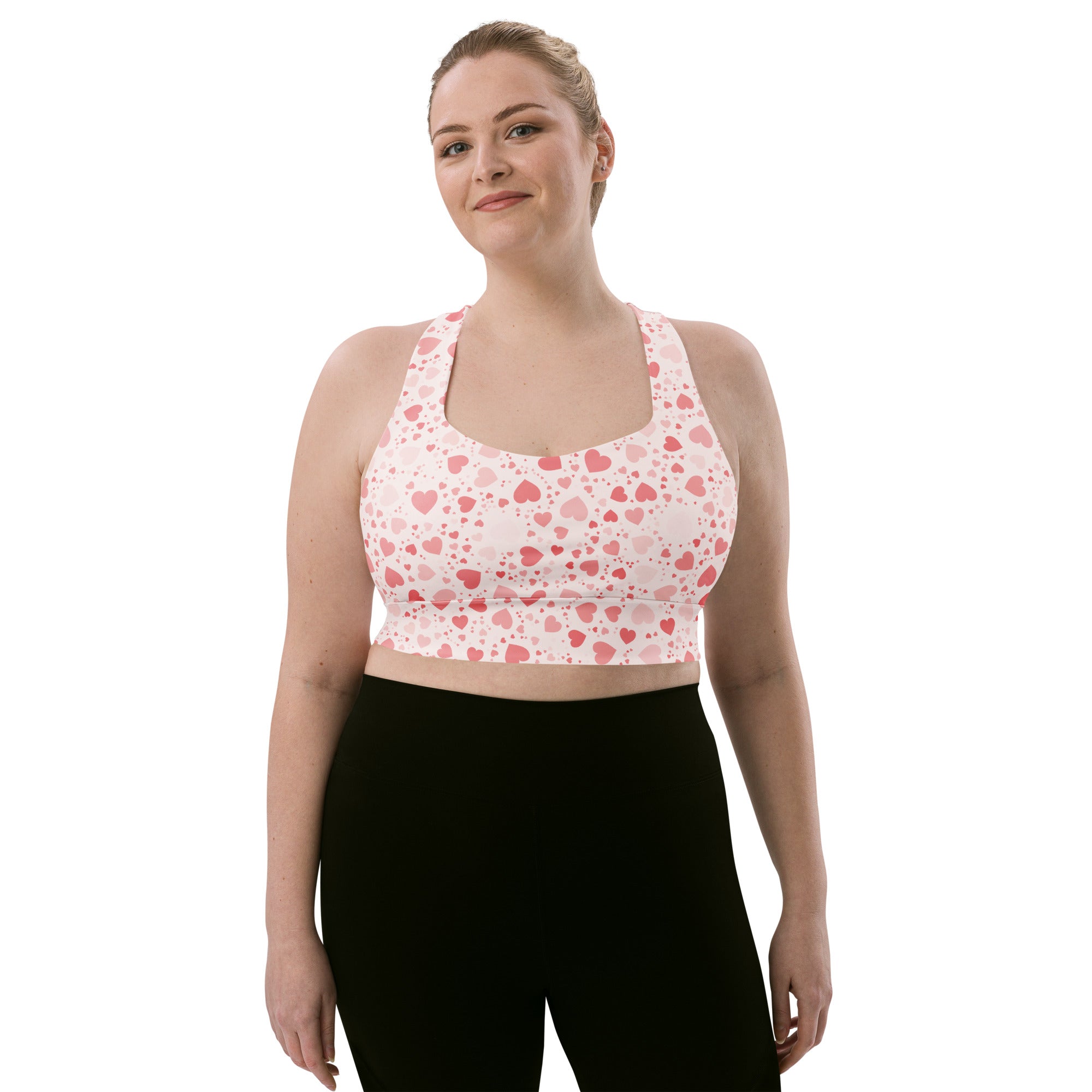 Women’s pink and white heart pattern longline sports bra with buttery soft recycled fabric and racerback straps