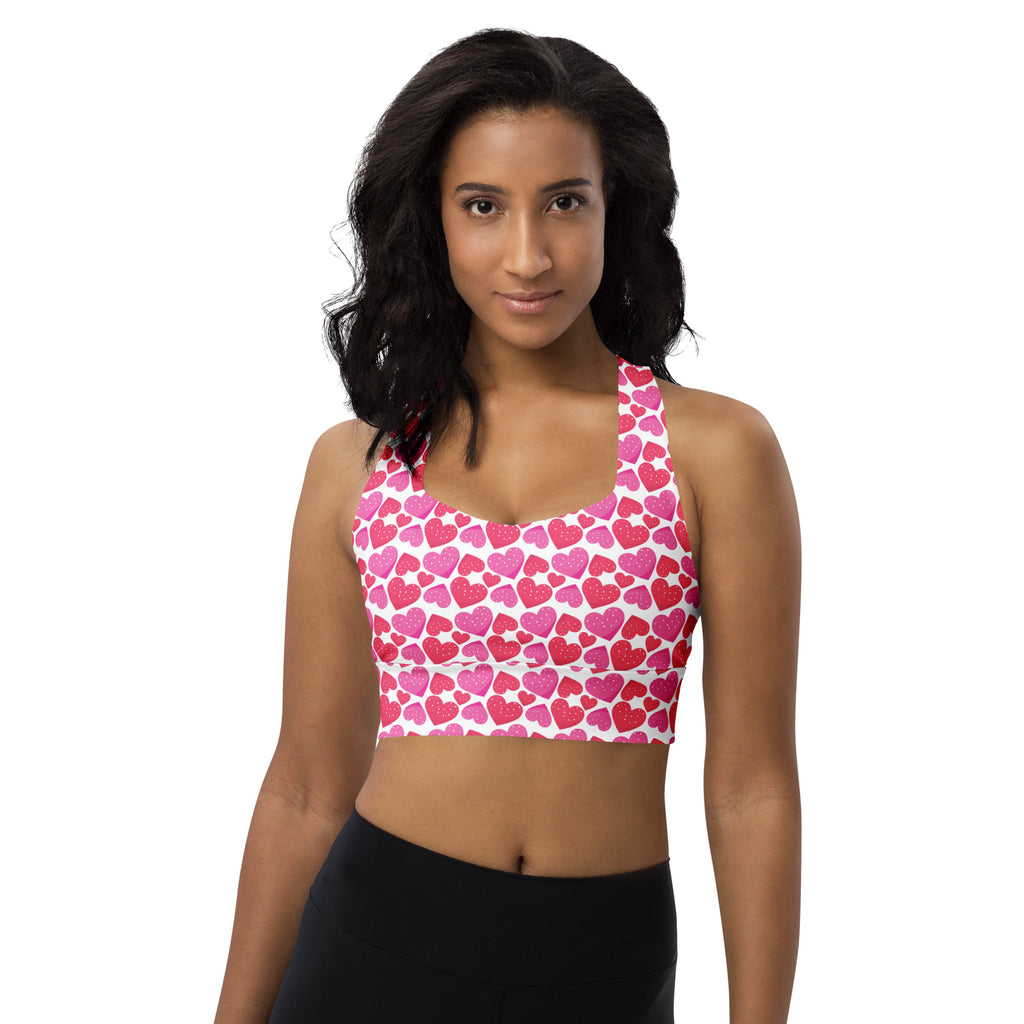 Women’s pink and white heart-patterned buttery soft recycled longline sports bra with halter neckline and high support