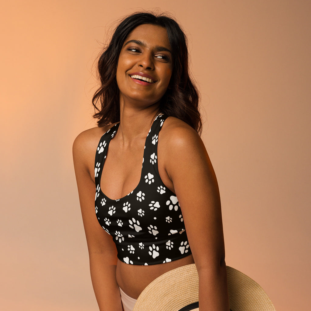 Women’s black sports bra with white paw print pattern made from buttery soft recycled fabric for high intensity support