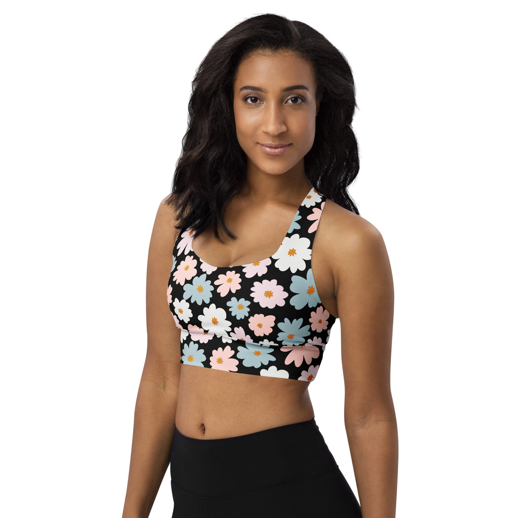 Women’s black longline sports bra with vibrant pink white and blue daisy floral pattern high intensity support
