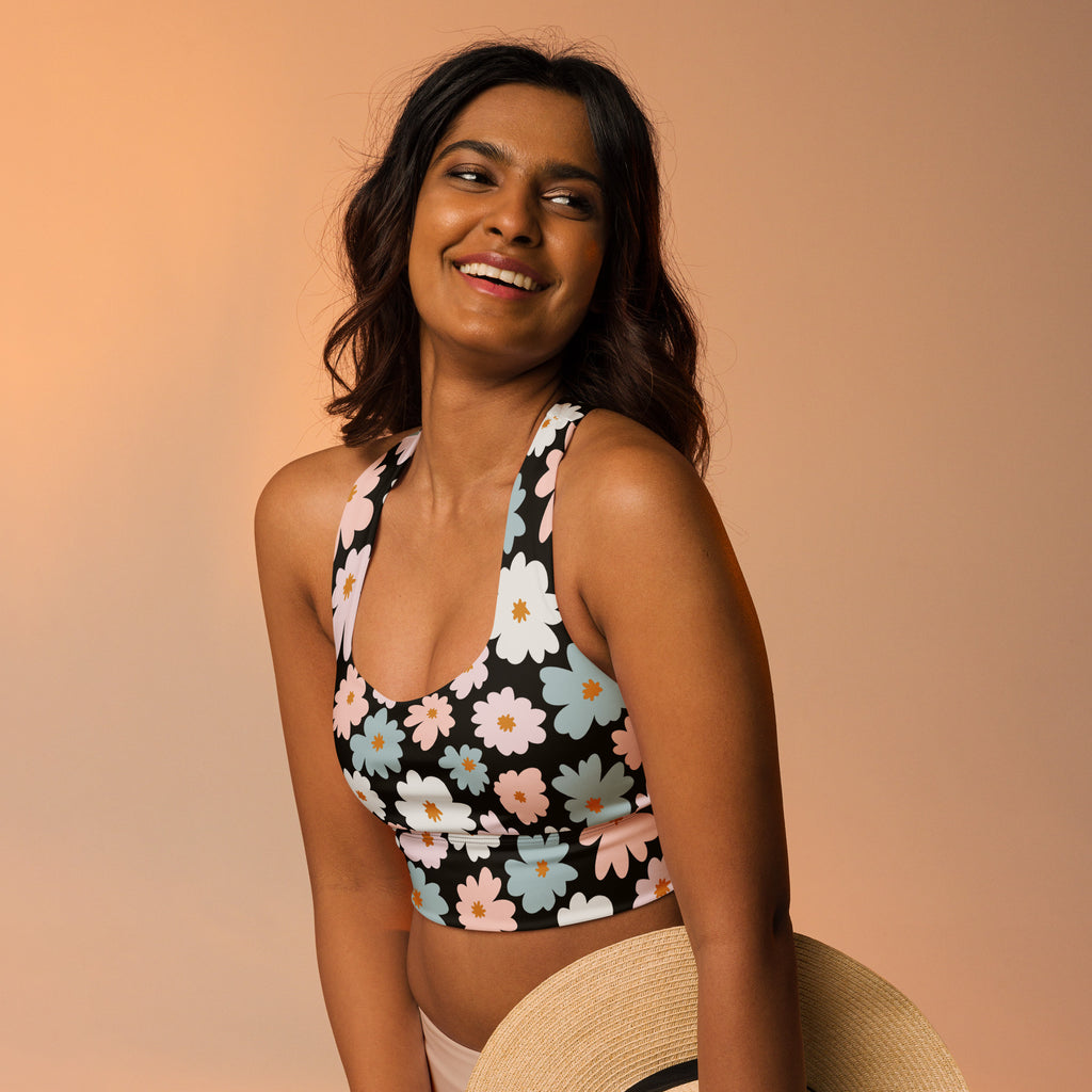 Black halter-neck crop top with white pink and light blue daisies buttery soft recycled sports bra with upf 50+