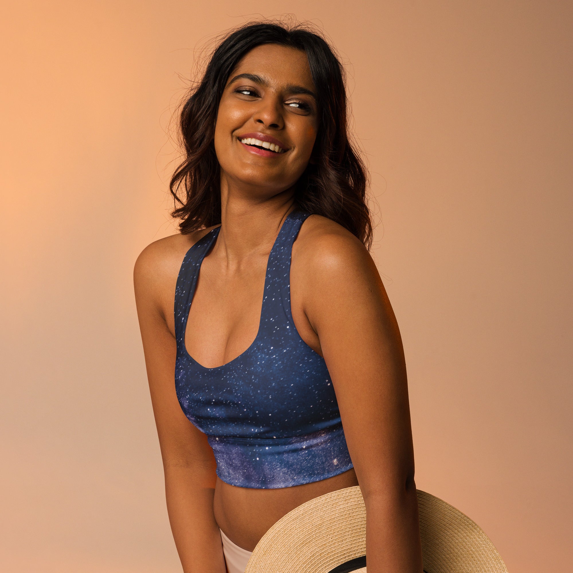 Blue galaxy-print longline sports bra with halter neck made of buttery soft recycled fabric for high intensity support