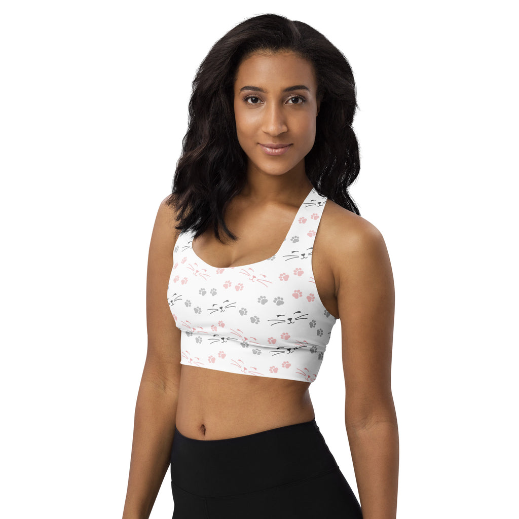 White longline sports bra with pink and gray cat face and paw print pattern buttery soft recycled fabric