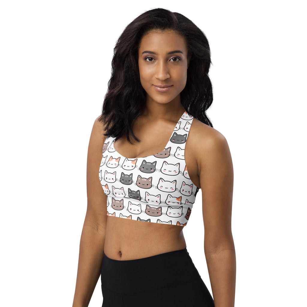 Women’s white longline sports bra with playful multicolor cartoon cat faces made from buttery soft recycled fabric