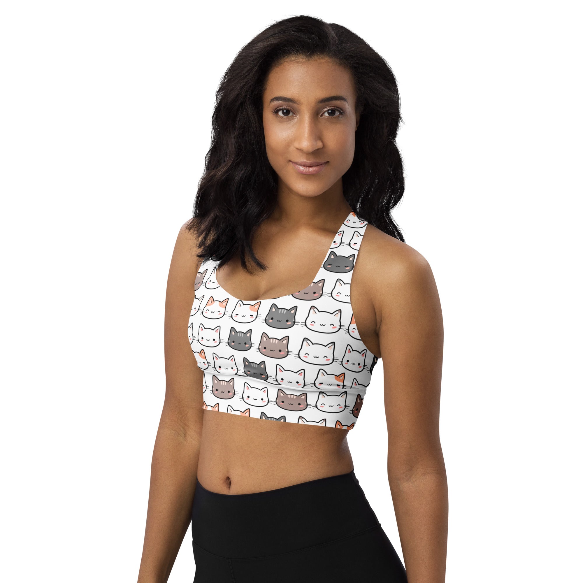 Women’s white longline sports bra with playful multicolor cartoon cat faces made from buttery soft recycled fabric