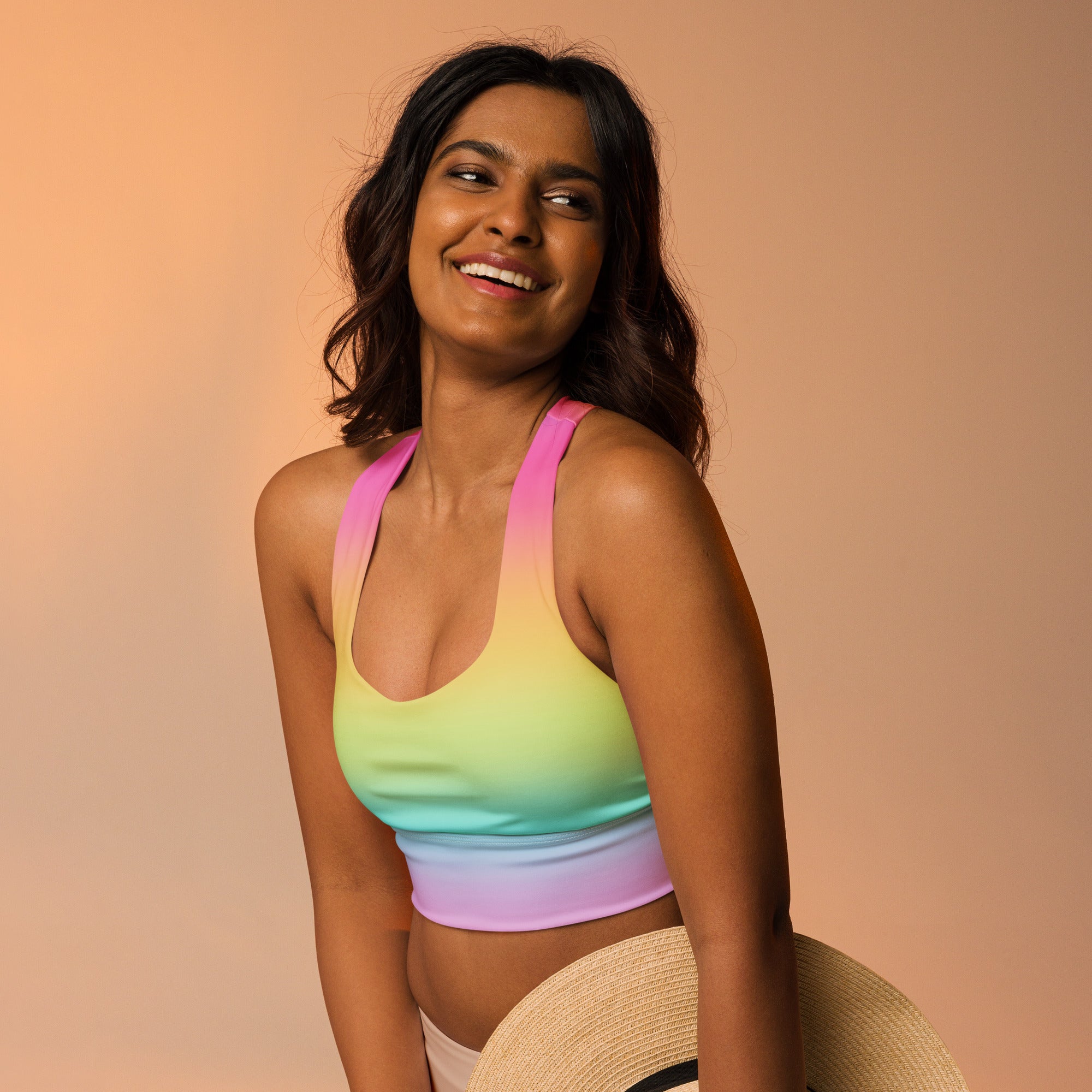 Women’s bright rainbow gradient sports bra made of stretchy fabric offers high intensity support and quick dry features