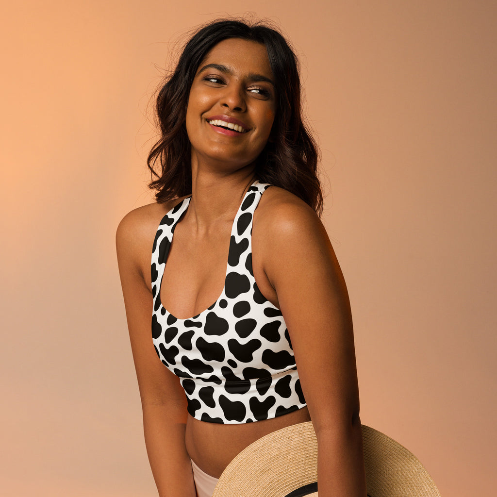 Women’s black and white cow print buttery soft recycled longline sports bra with high intensity support and removable padding