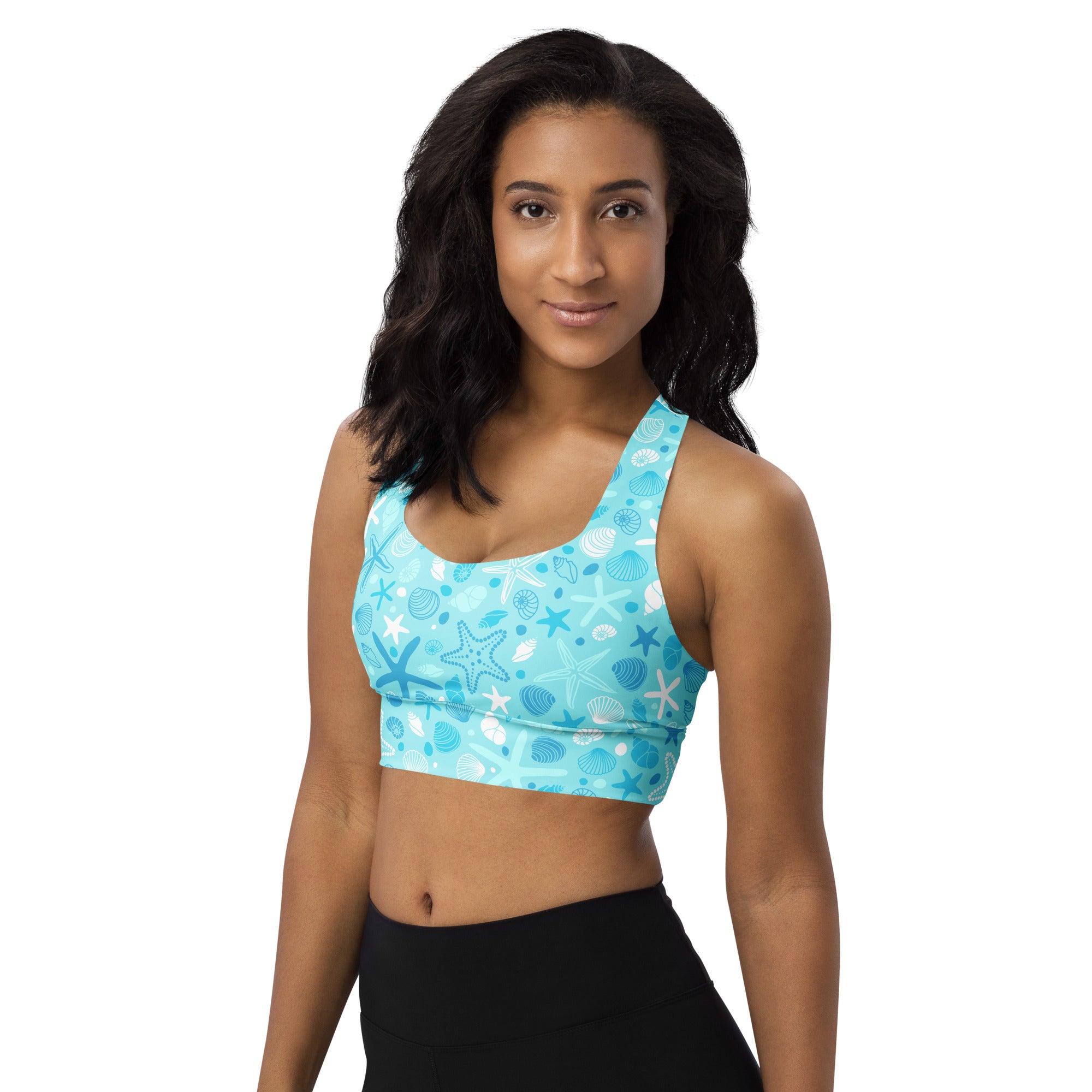 A light blue longline sports bra with white and dark blue seashell and starfish pattern for high intensity support