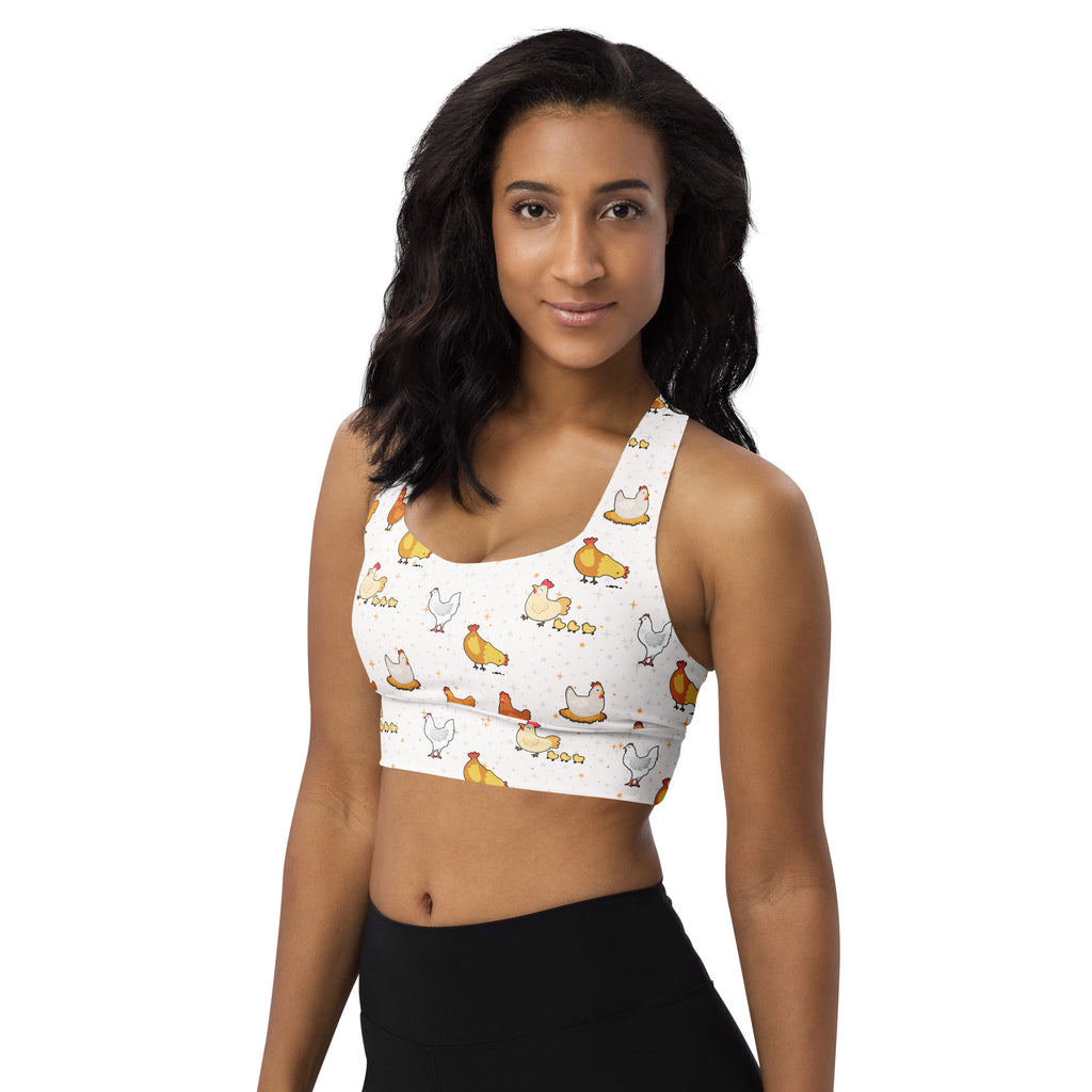 White longline sports bra with playful yellow and white cartoon chickens made from buttery soft recycled fabric