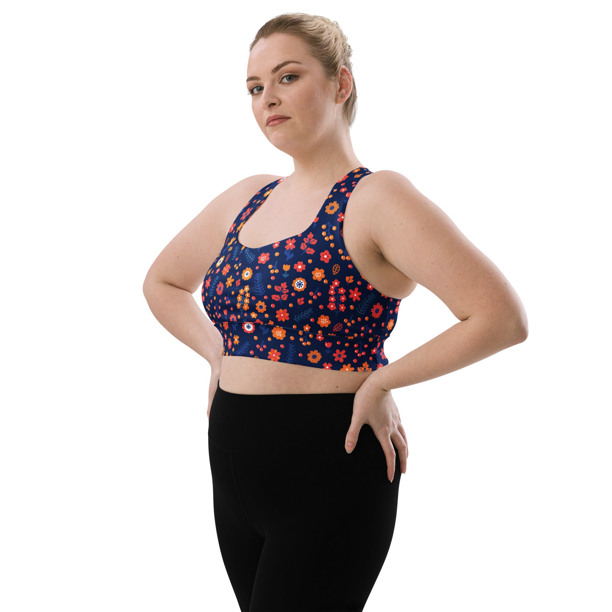Women’s navy blue longline sports bra with orange red yellow floral pattern made from recycled fabric for high intensity support