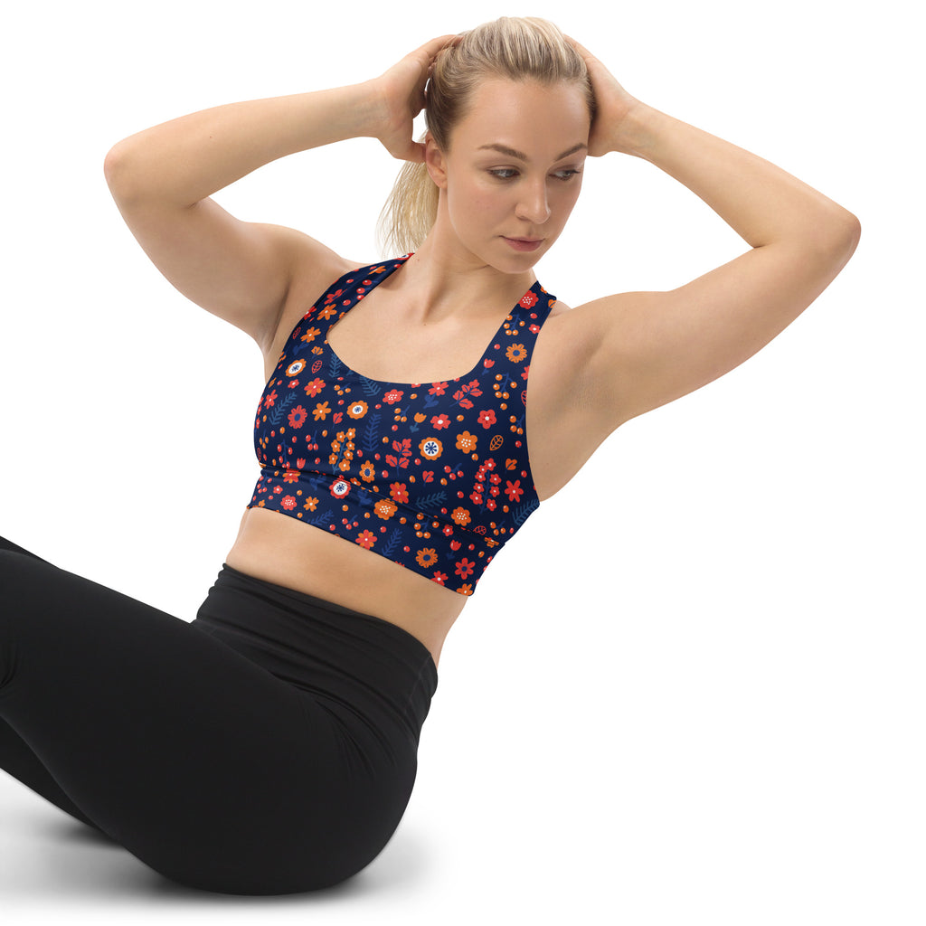 Women’s navy blue floral print recycled longline sports bra with orange and pink blossoms for high intensity support