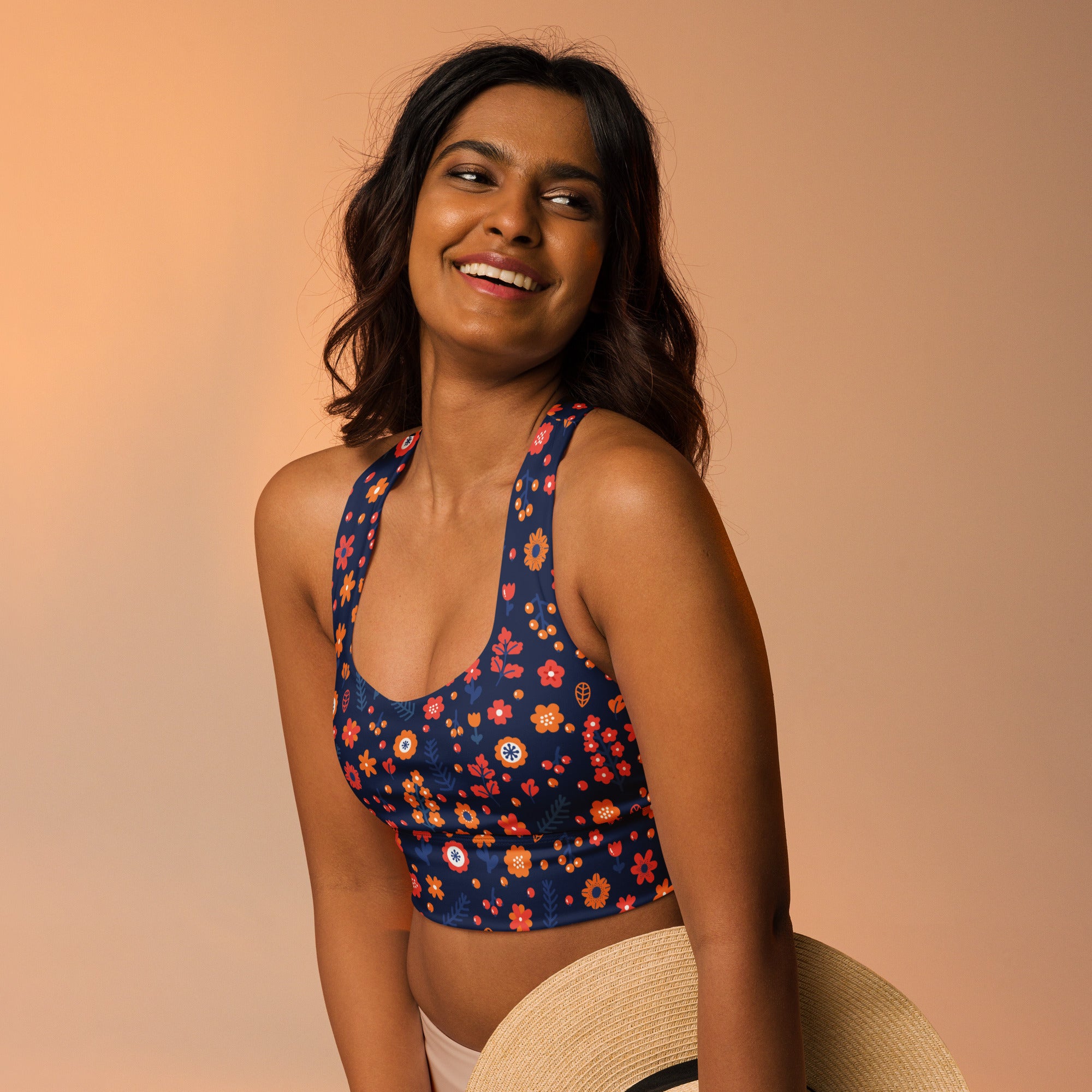 Women’s dark floral buttery soft recycled longline sports bra in navy blue with vibrant orange red and white flowers