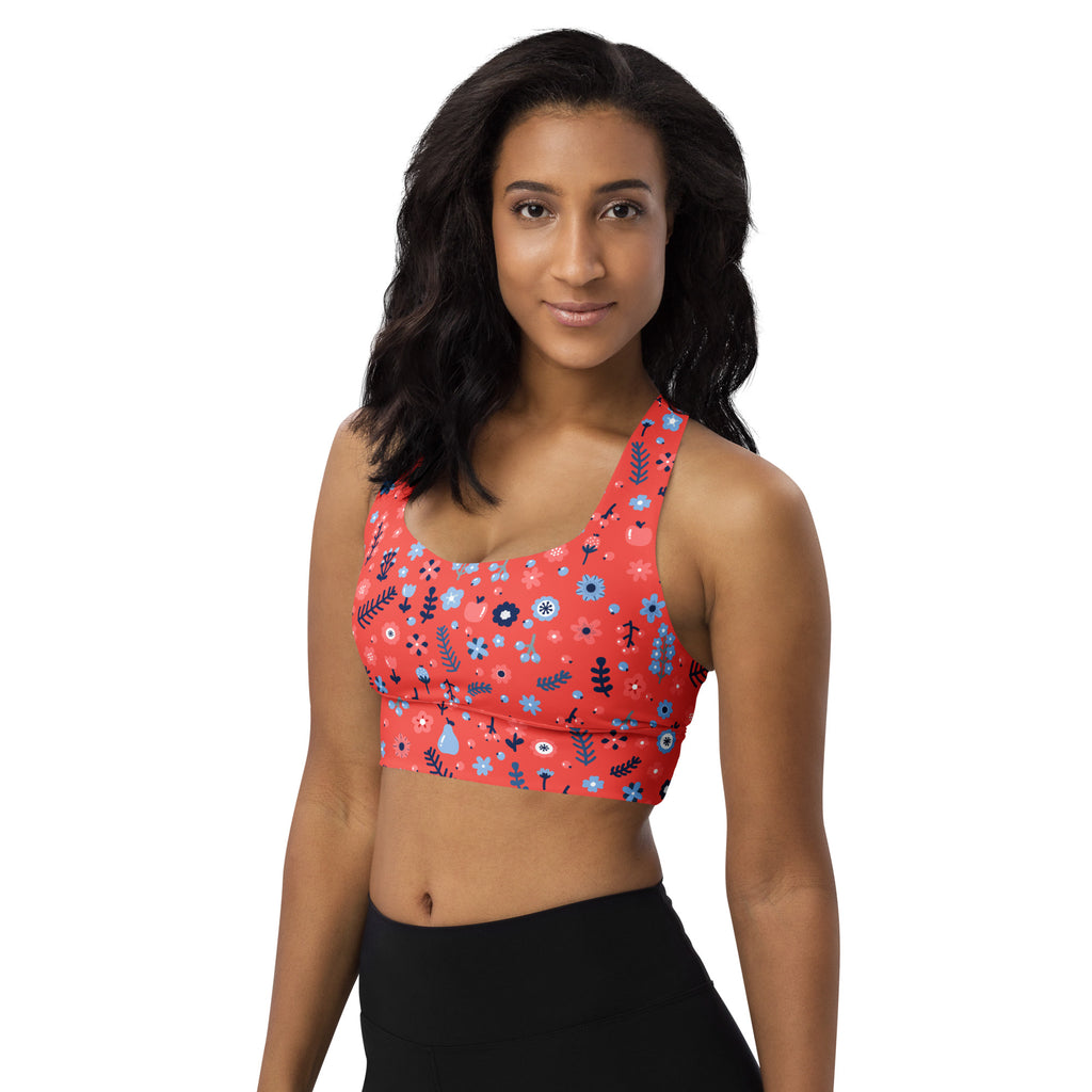 Women’s coral red floral buttery soft recycled longline sports bra with blue white and black botanical pattern for high intensity support