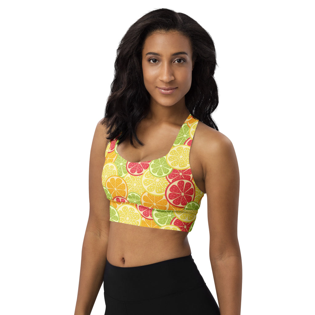 Women’s longline sports bra with vibrant citrus slice pattern in yellow green and red buttery soft recycled fabric