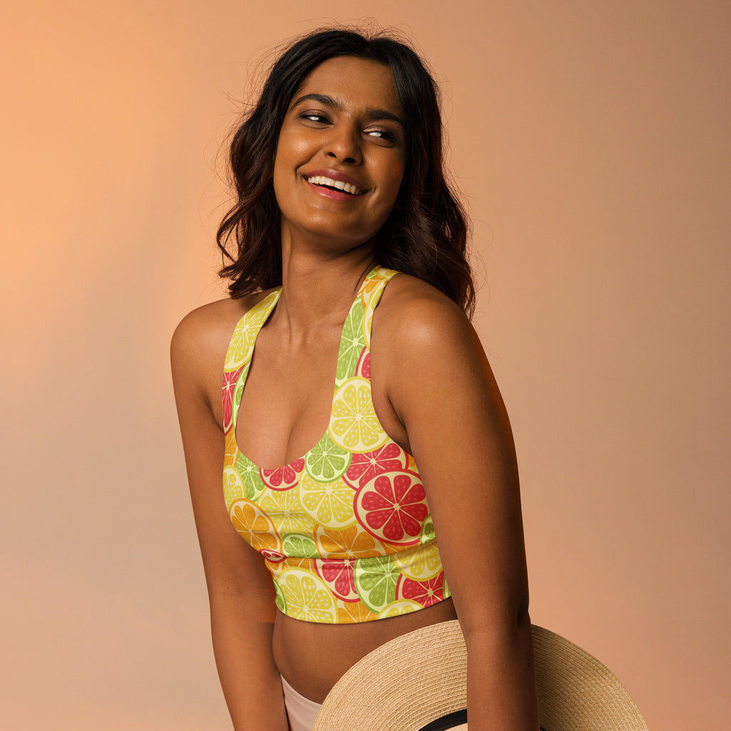 A vibrant citrus print buttery soft recycled fabric crop top sports bra with halter neck straps and high intensity support