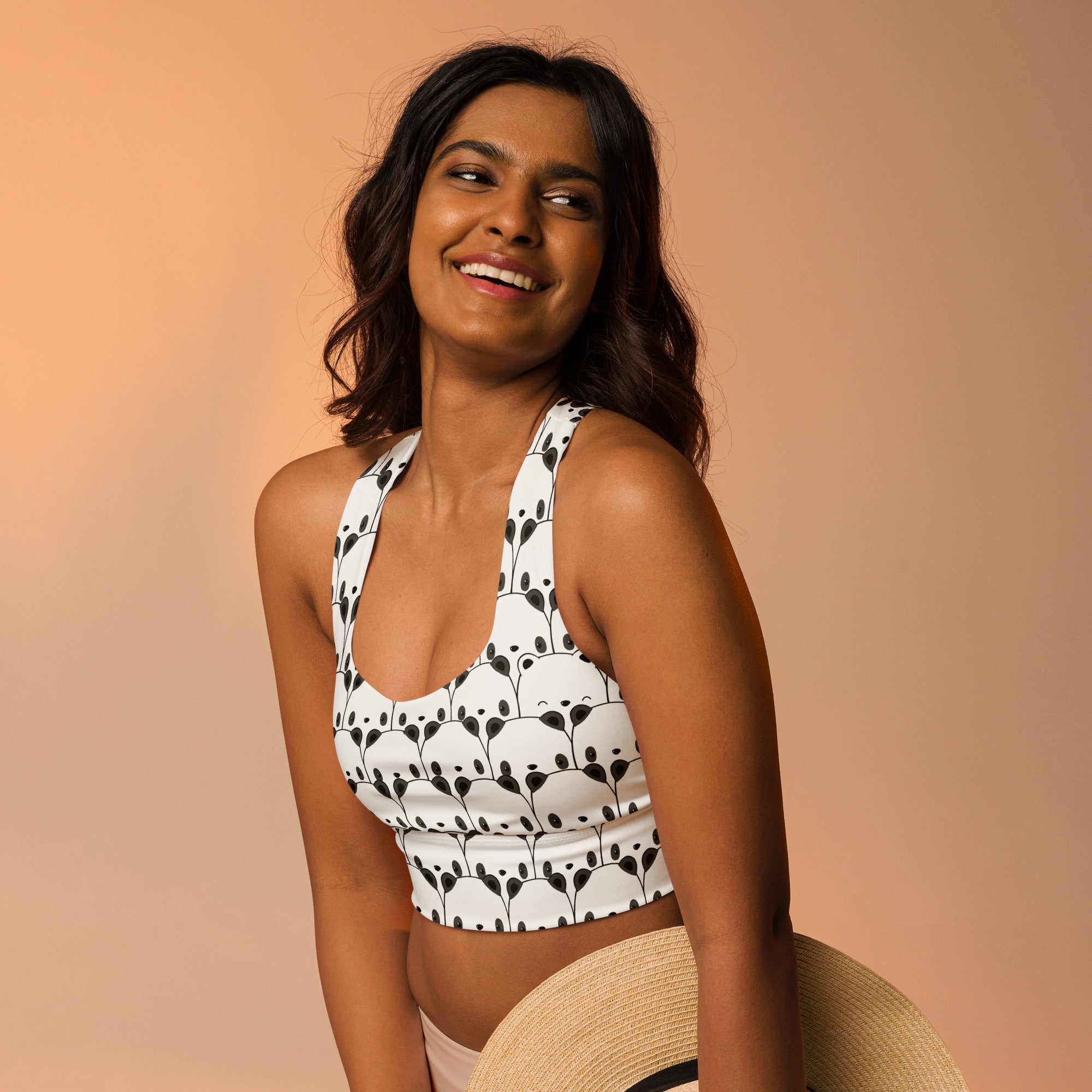 Women’s white longline sports bra with black panda face pattern buttery soft recycled fabric high intensity support