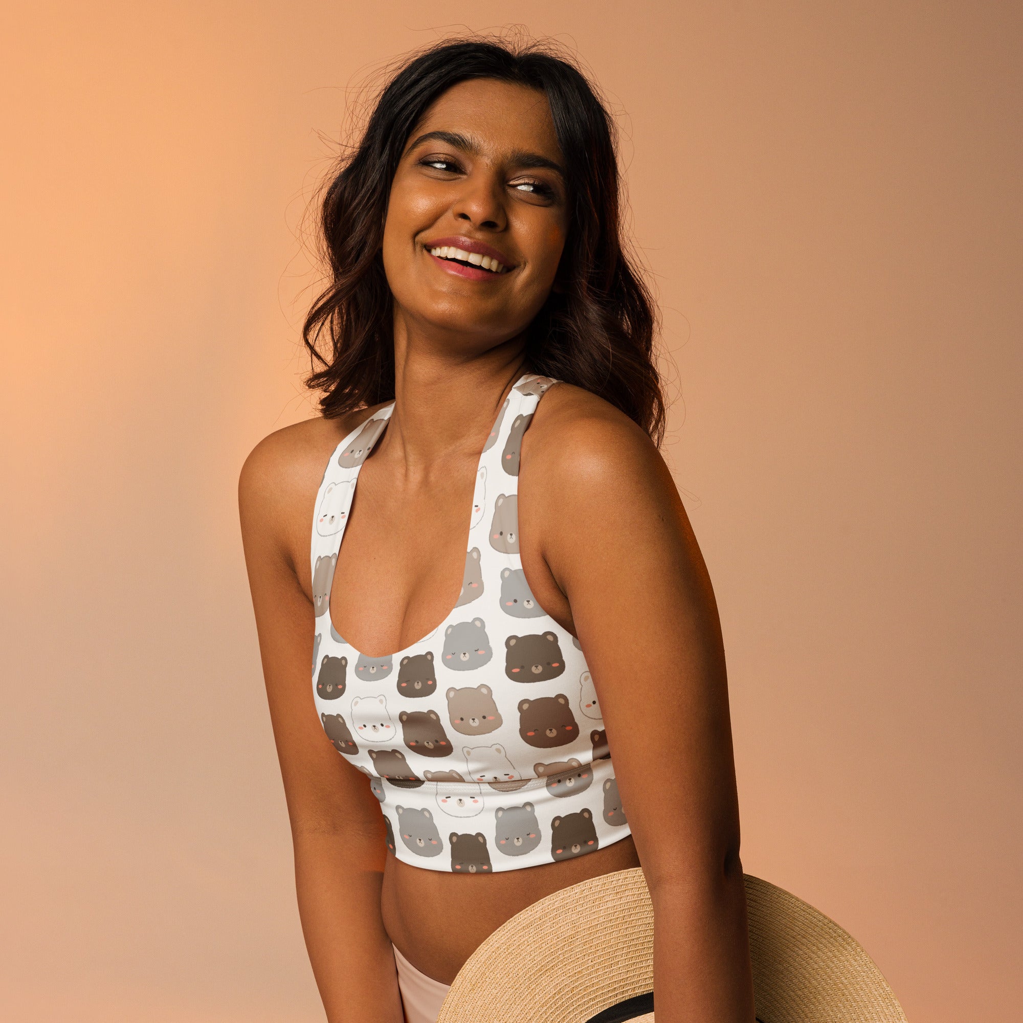 White longline sports bra with playful gray and brown cartoon bear faces made from buttery soft recycled fabric