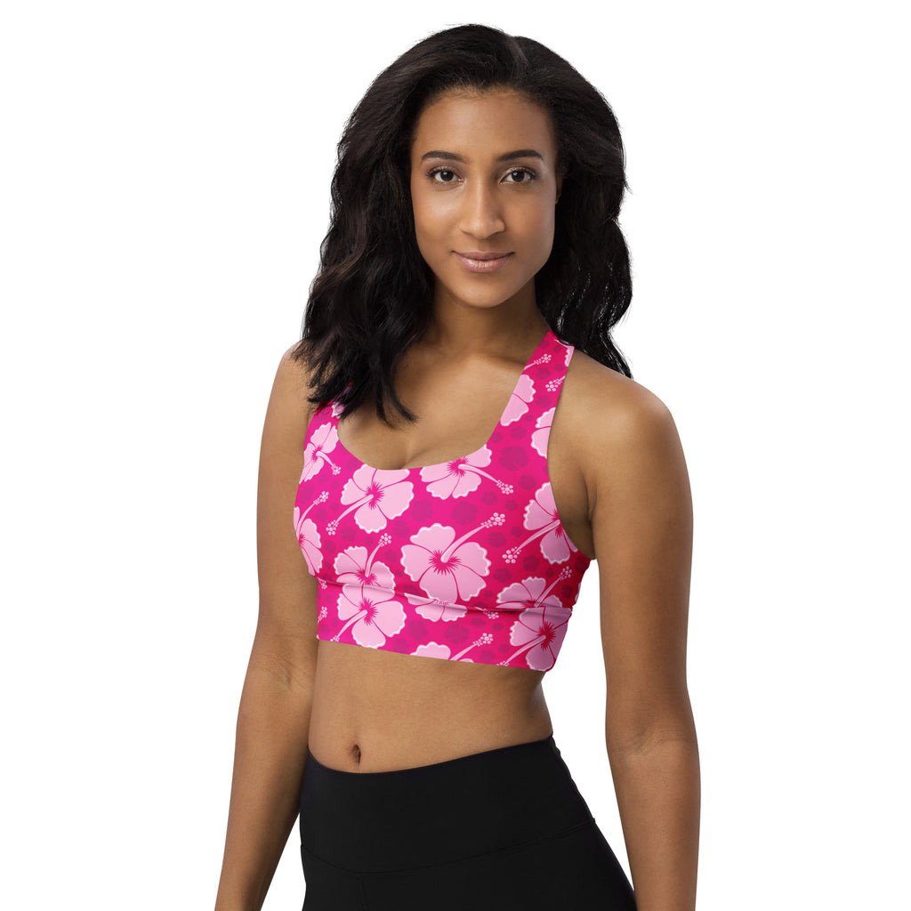 Women’s vibrant pink hibiscus buttery soft recycled longline sports bra with high intensity support and quick dry features