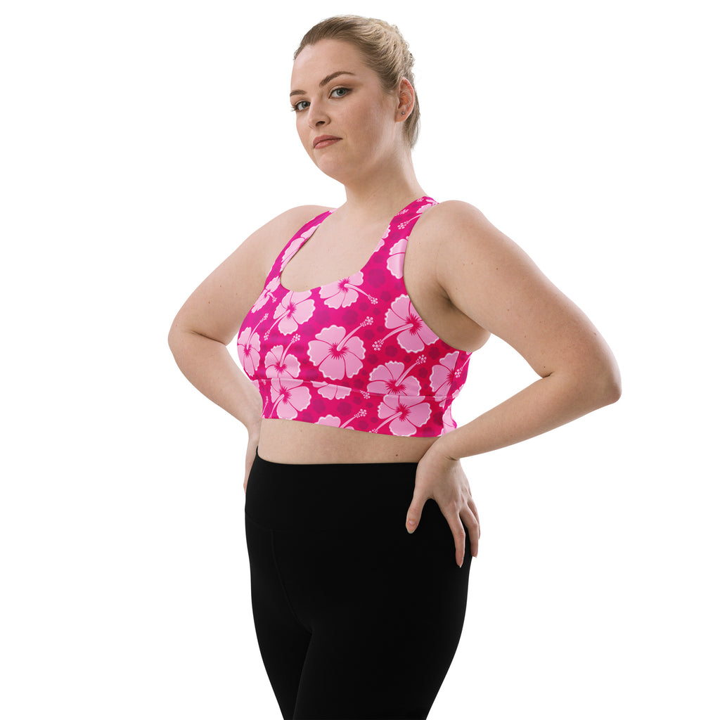 Women’s vibrant pink sports bra with bold lighter pink and white hibiscus pattern buttery soft recycled fabric