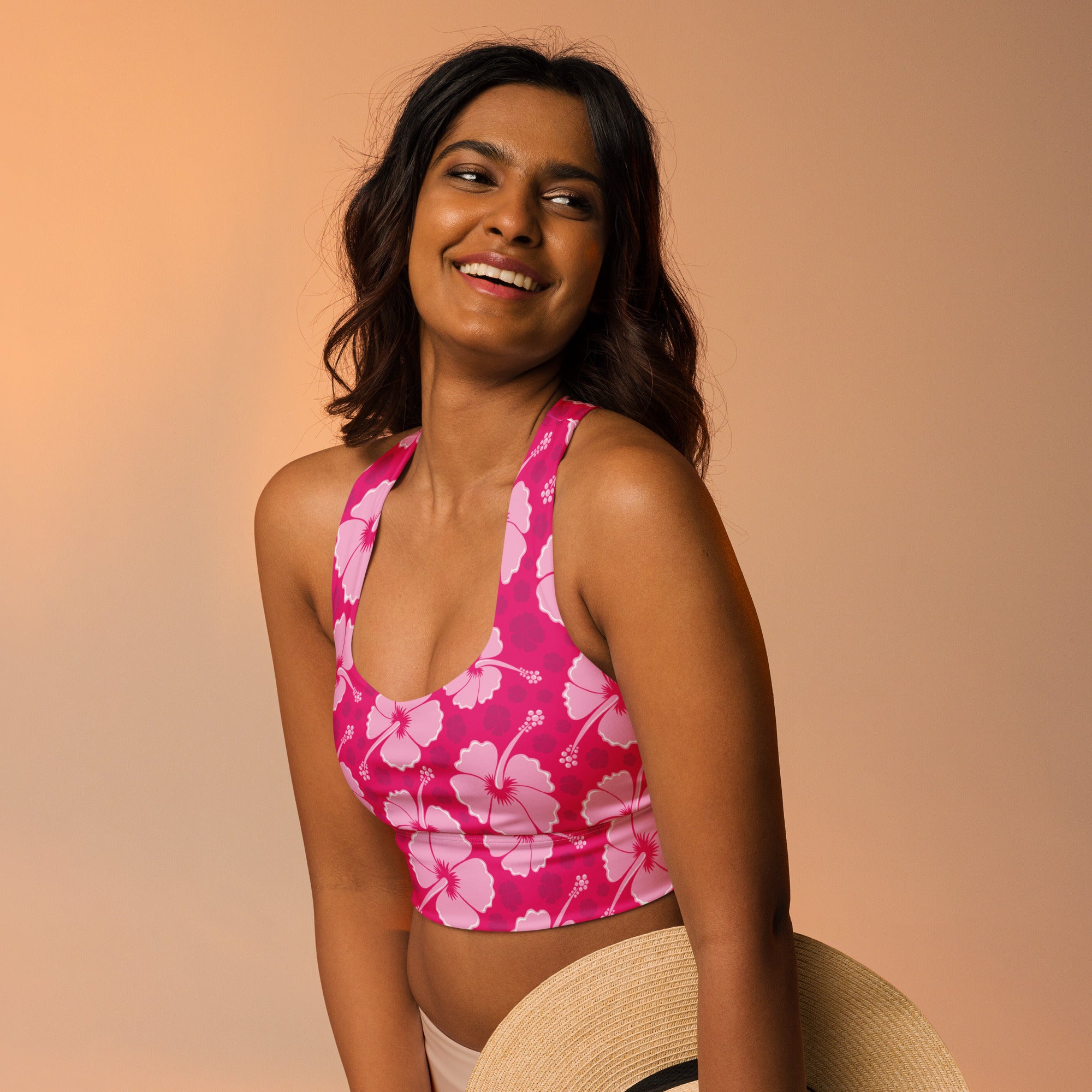 Women’s pink hibiscus halter top sports bra with white flower pattern buttery soft recycled fabric and upf 50 plus