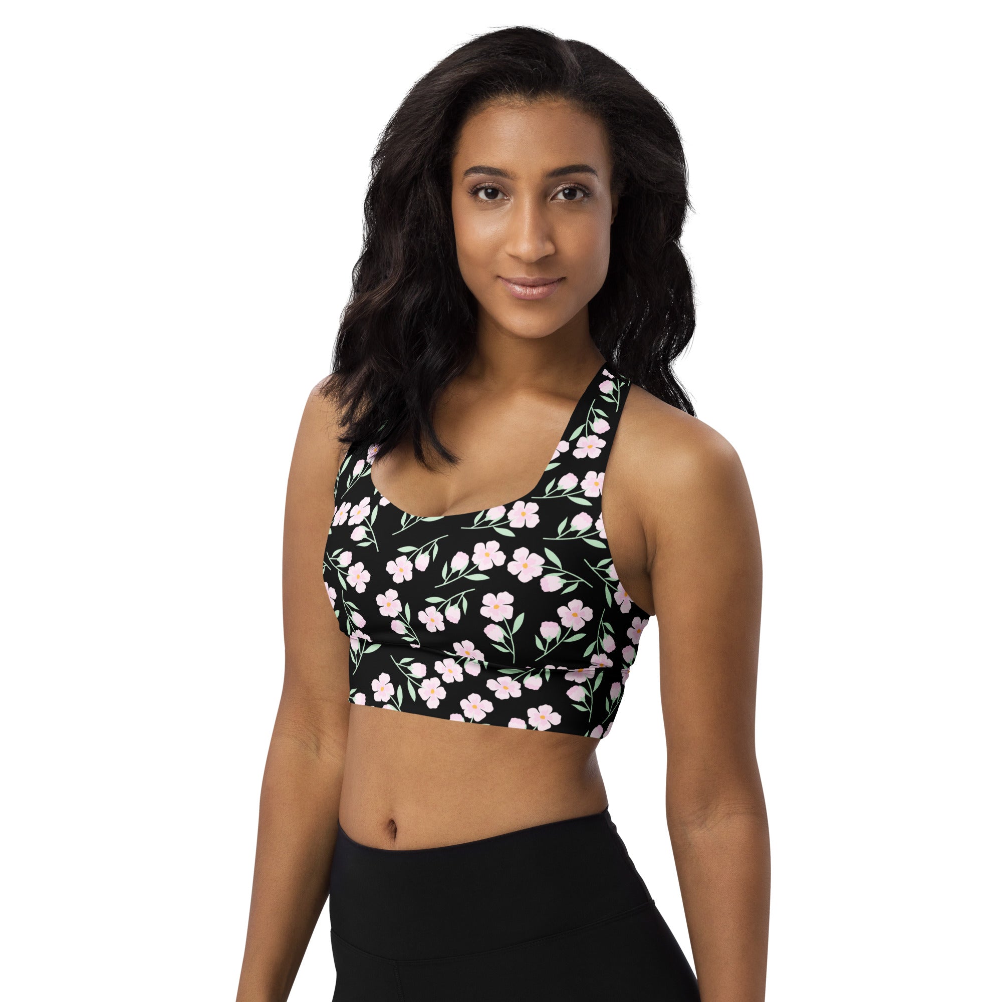 Women’s black floral print buttery soft recycled longline sports bra with delicate pink pattern and thin straps