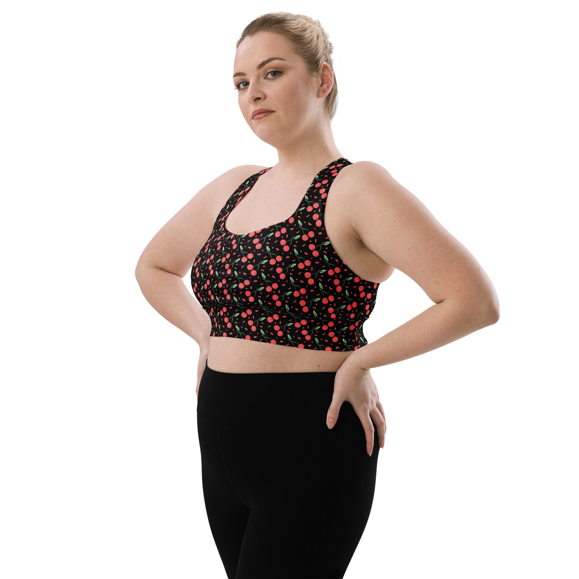 Black longline sports bra with red and green cherry pattern made from buttery soft recycled fabric for high intensity support