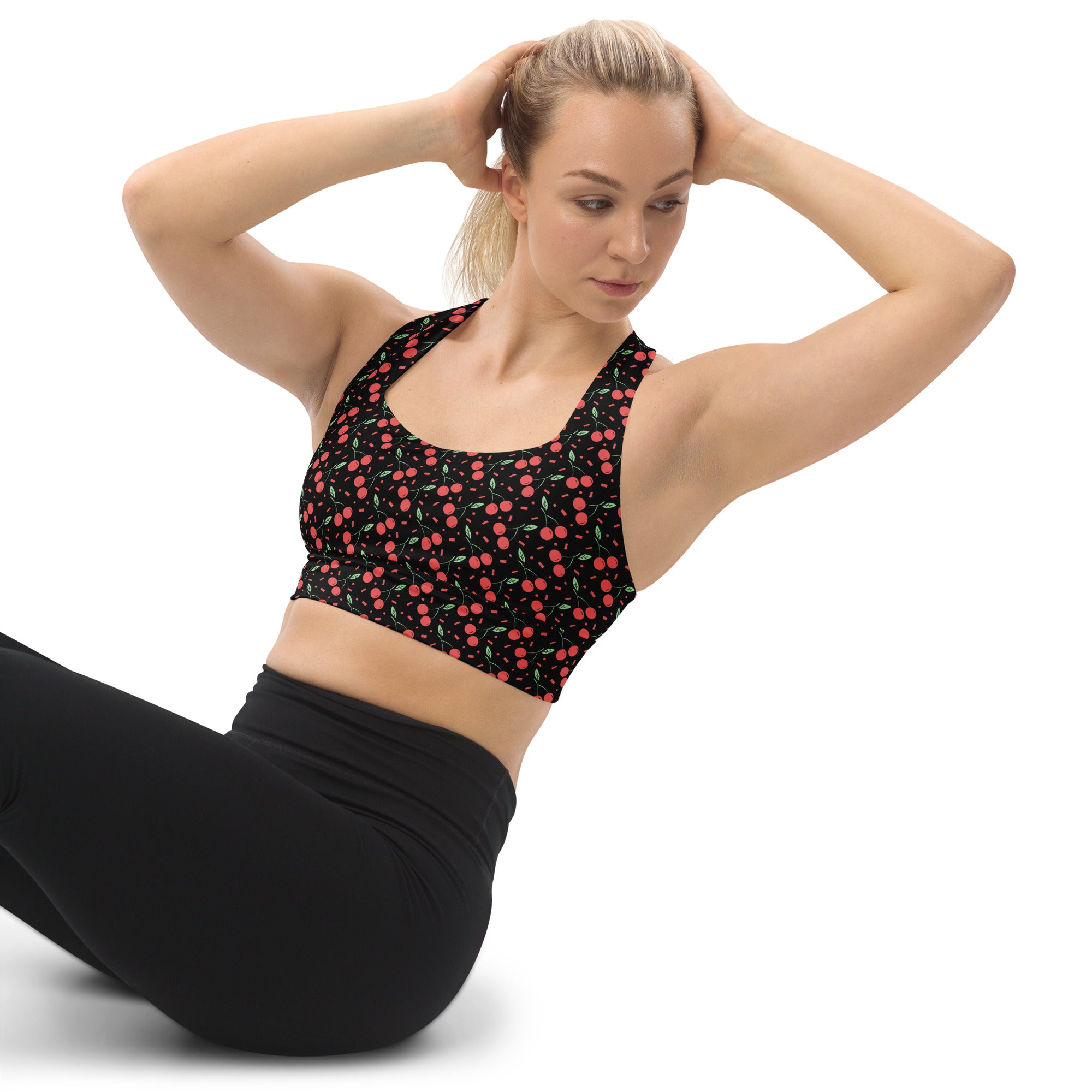Women’s black sports bra with pink cherry pattern green stems buttery soft recycled fabric high intensity support