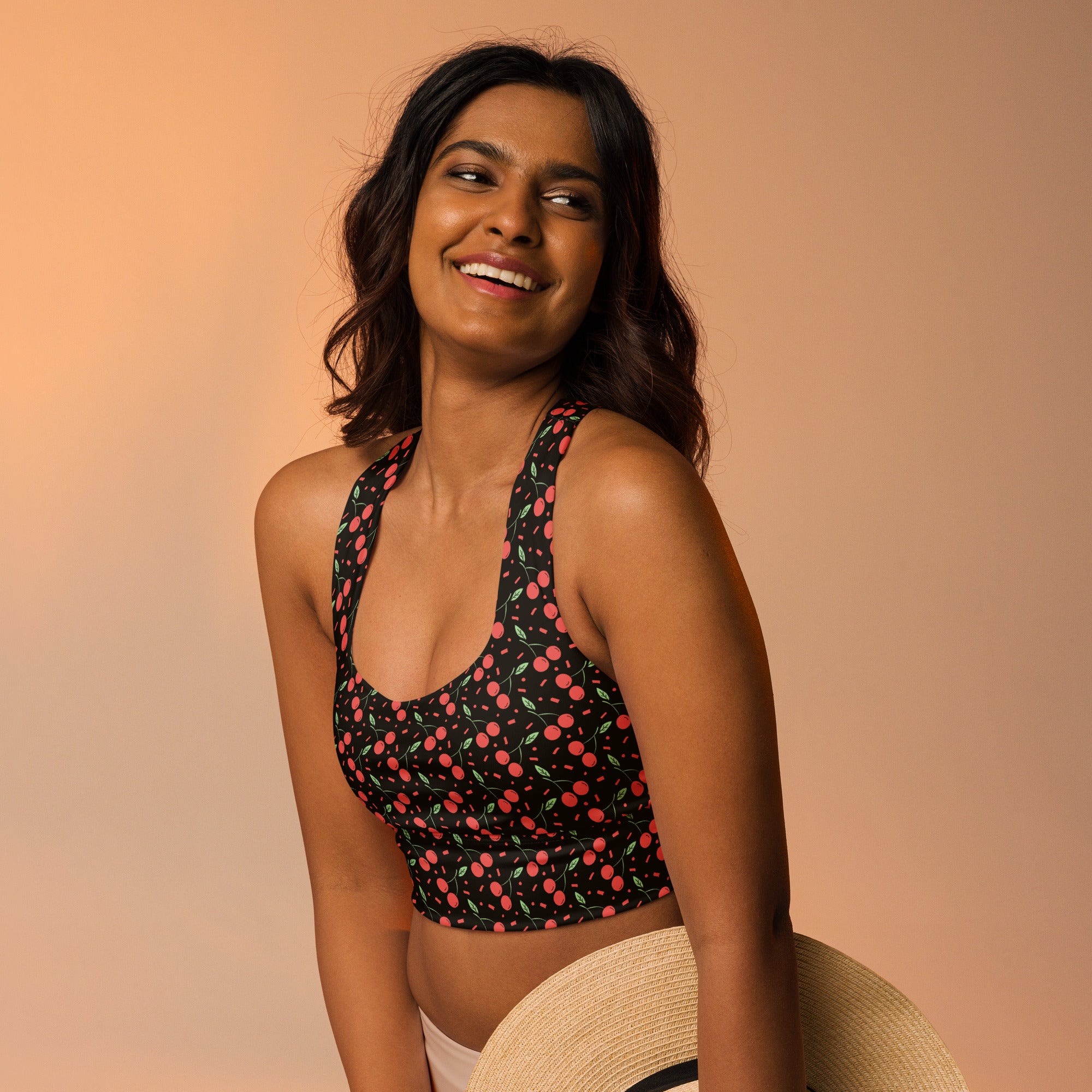 Women’s black halter sports bra with playful pink and green cherry print buttery soft recycled fabric high intensity support
