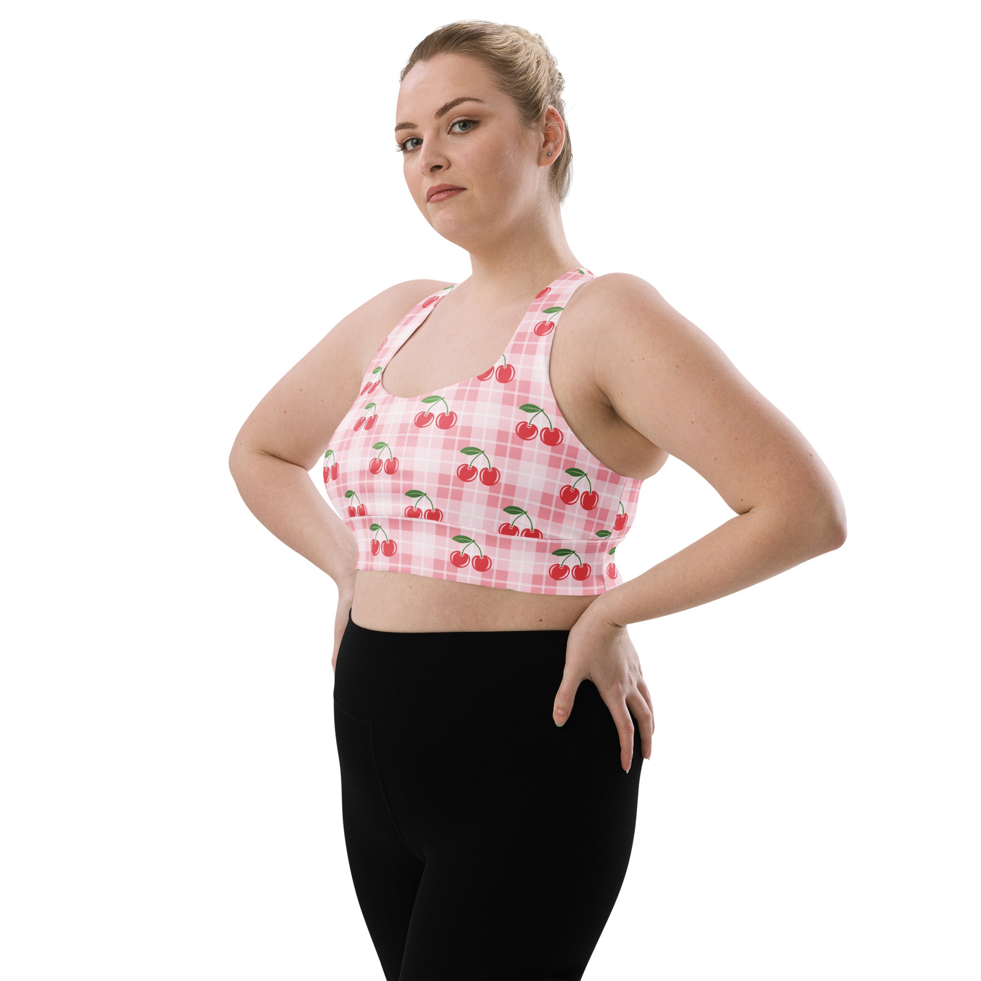 Women’s pink and white plaid buttery soft recycled longline sports bra with red cherry pattern and high intensity support