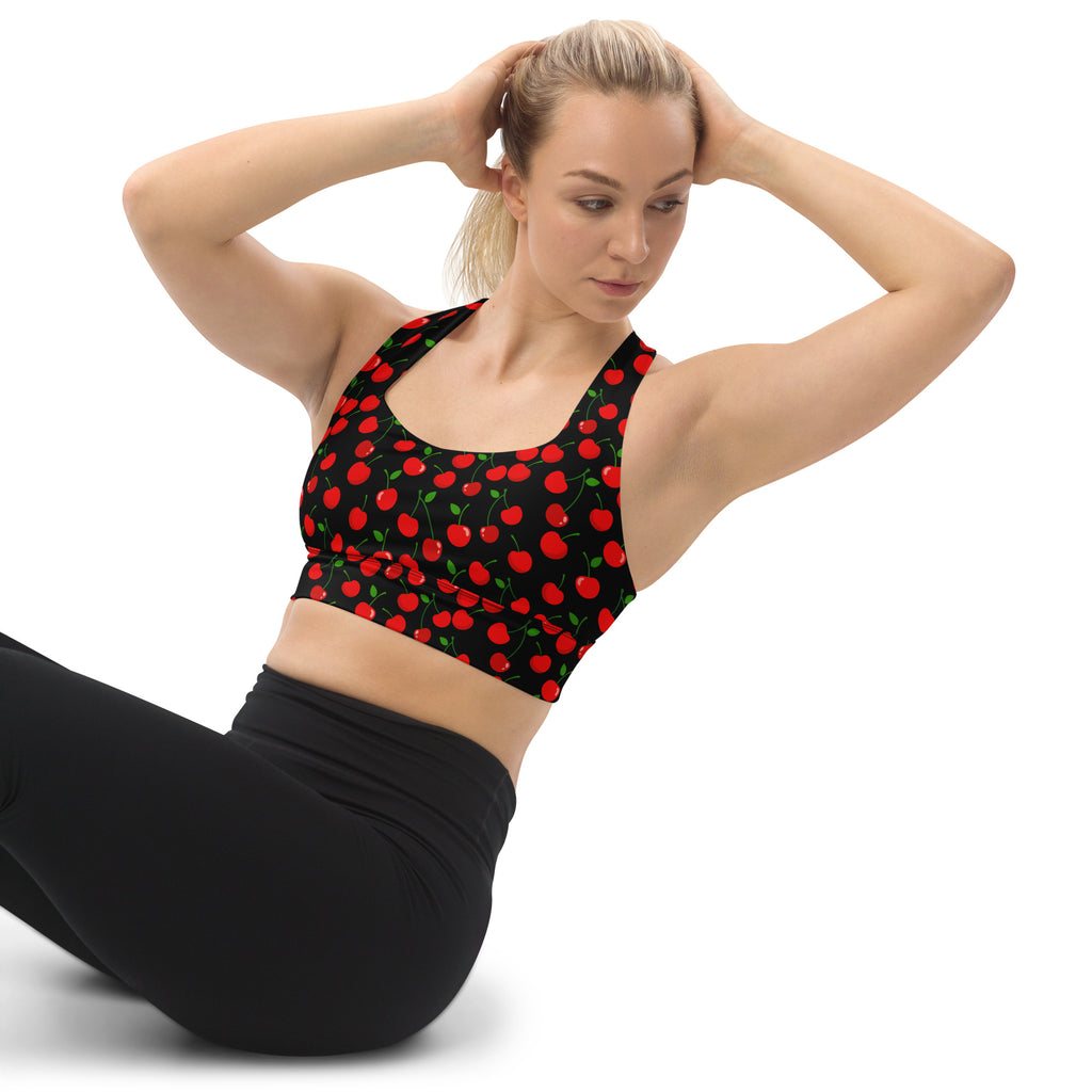 Women’s black longline sports bra with vibrant red cherry print green stems buttery soft recycled fabric high intensity support