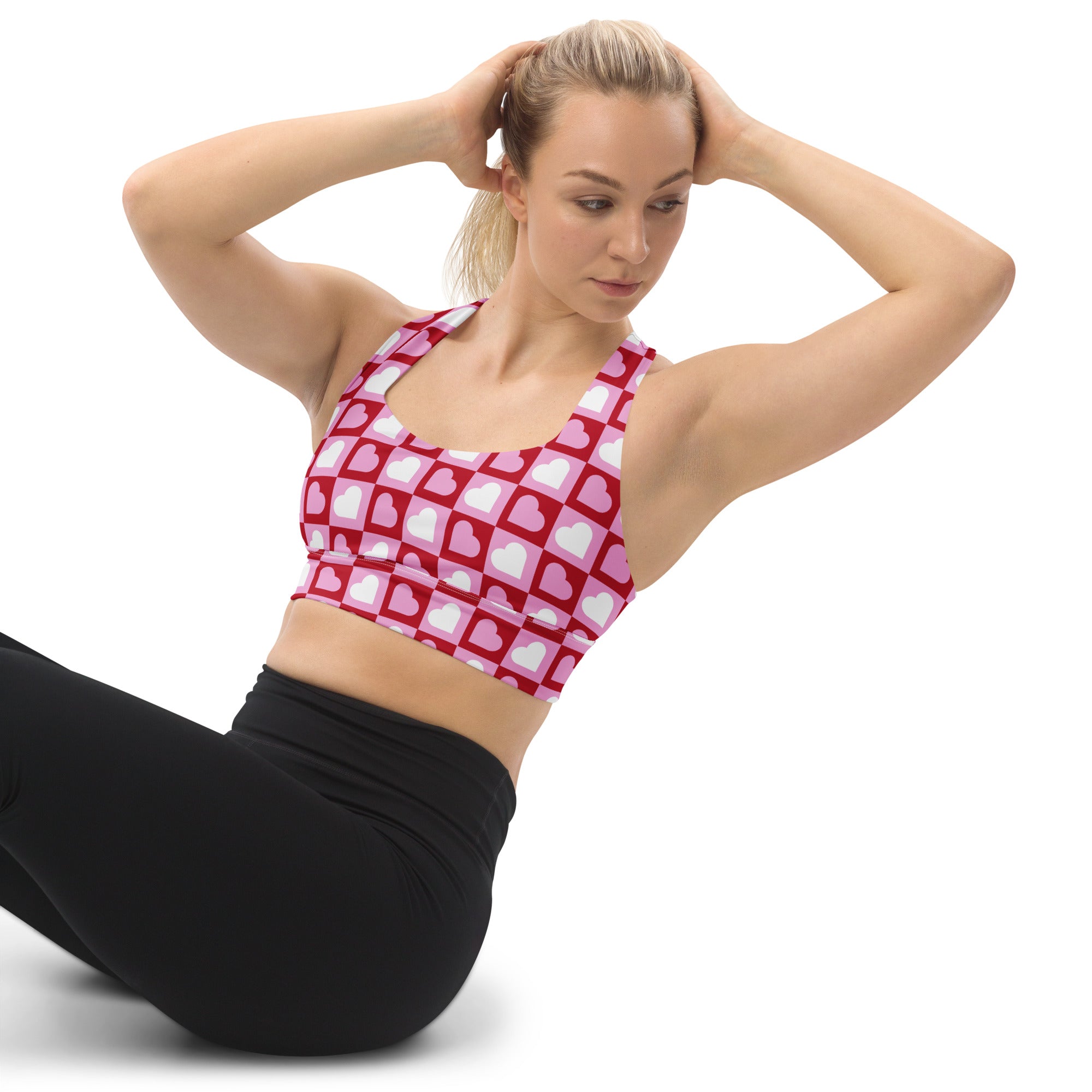 Women’s red and white heart-patterned buttery soft recycled longline sports bra with high intensity support and quick dry
