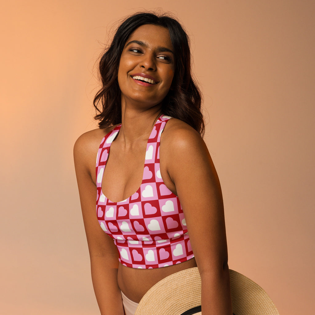 Women’s pink and white heart print halter top sports bra with buttery soft recycled fabric and high intensity support
