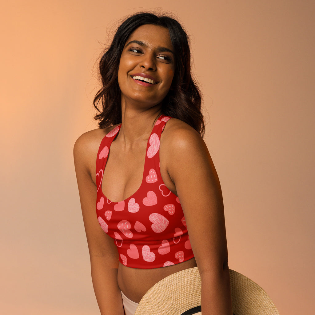 Women’s red heart pattern buttery soft recycled longline sports bra with pink and white hearts on stretchy fabric