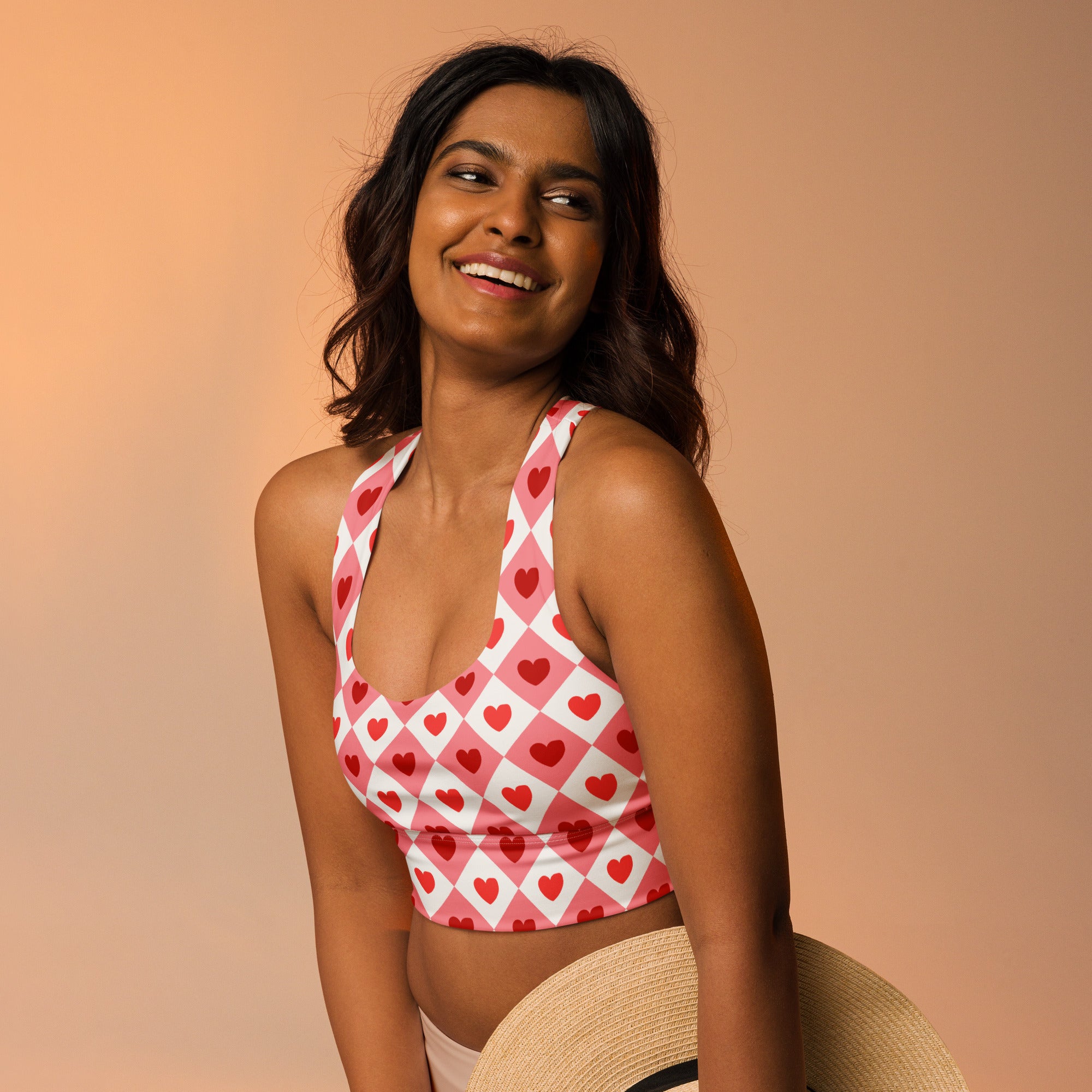 Women’s valentine’s day pink and white heart patterned crop top with halter neck, soft recycled fabric, high support sports bra