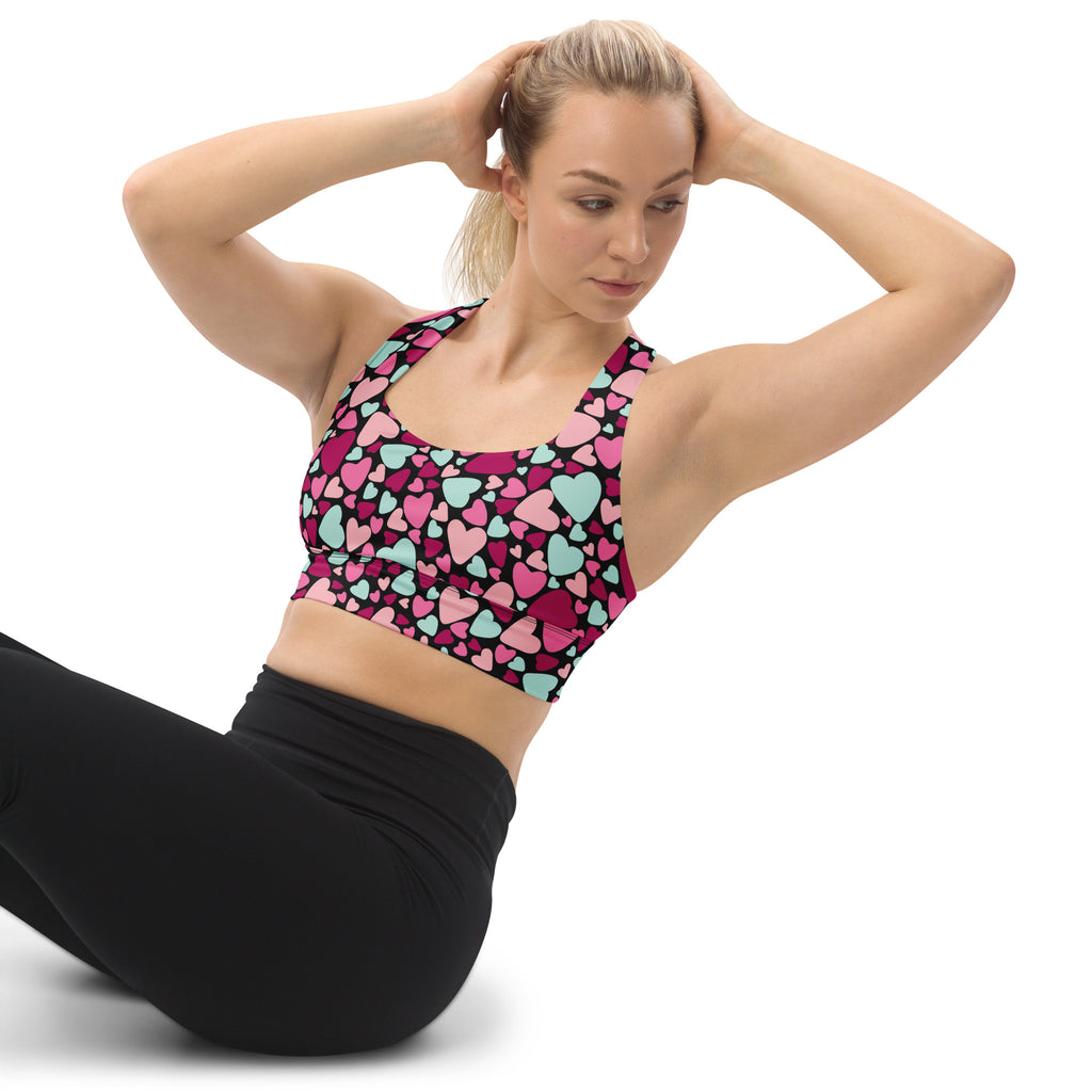 Vibrant pink and mint heart-patterned black base womens recycled longline sports bra with high support and quick dry features