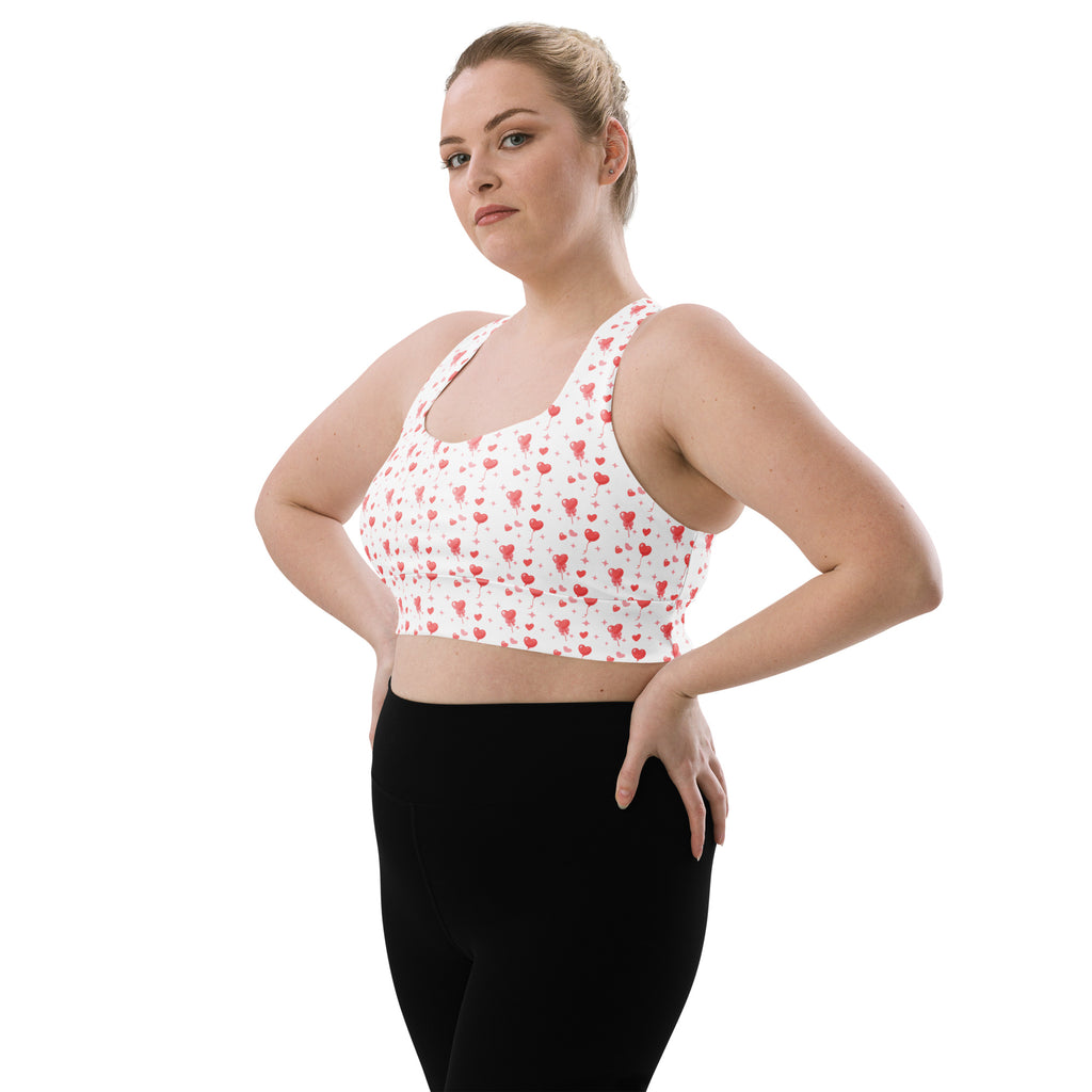 White buttery soft recycled longline sports bra with red heart pattern for high intensity support and quick dry use