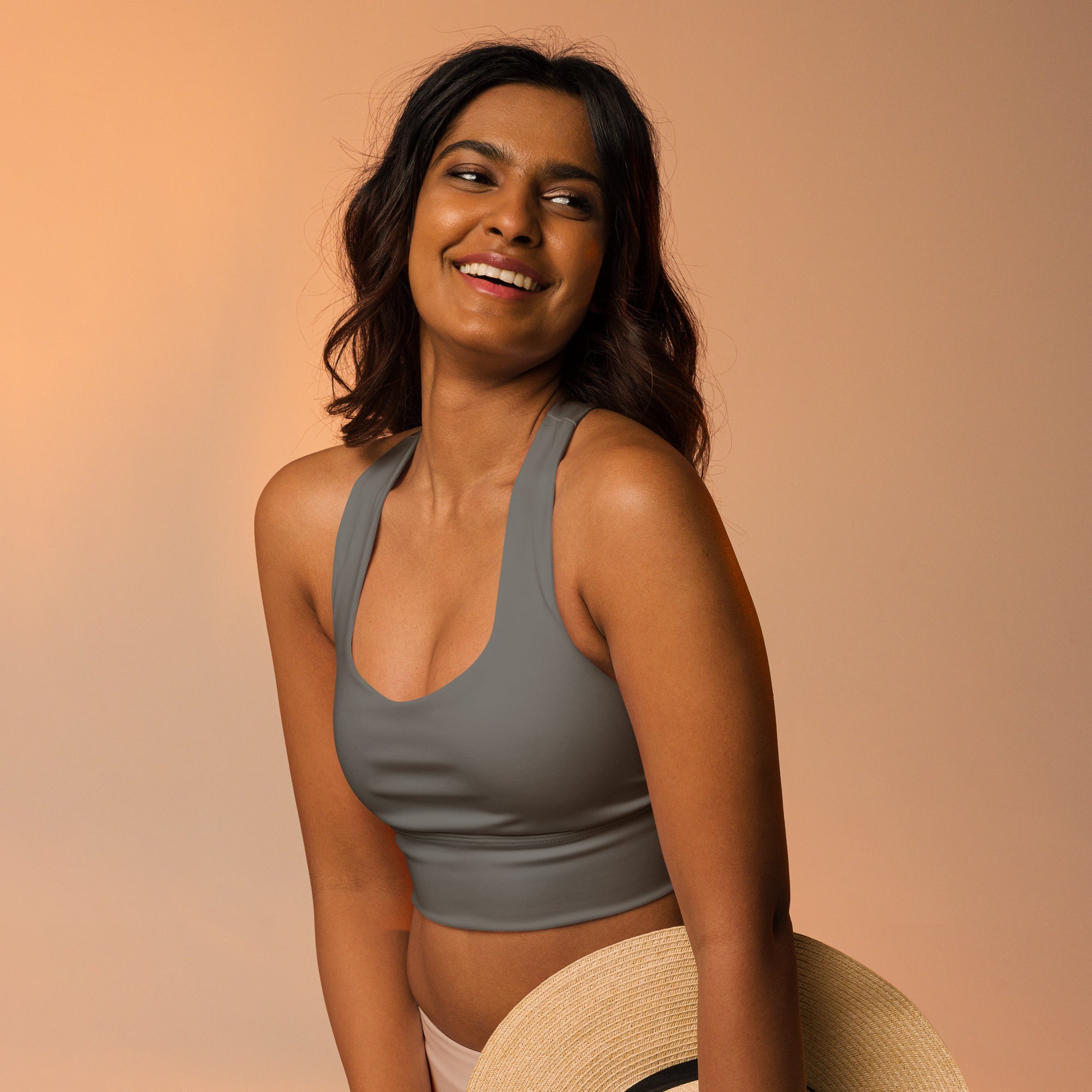 Gray halter-neck crop top made from buttery soft recycled fabric with high intensity support and quick dry features