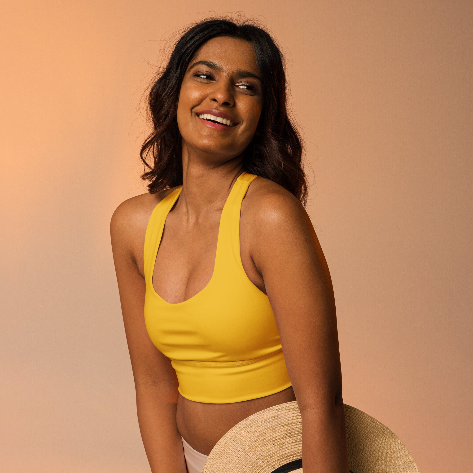 Yellow cropped sports bra with thin straps made from recycled fabric offers high intensity support and quick dry features