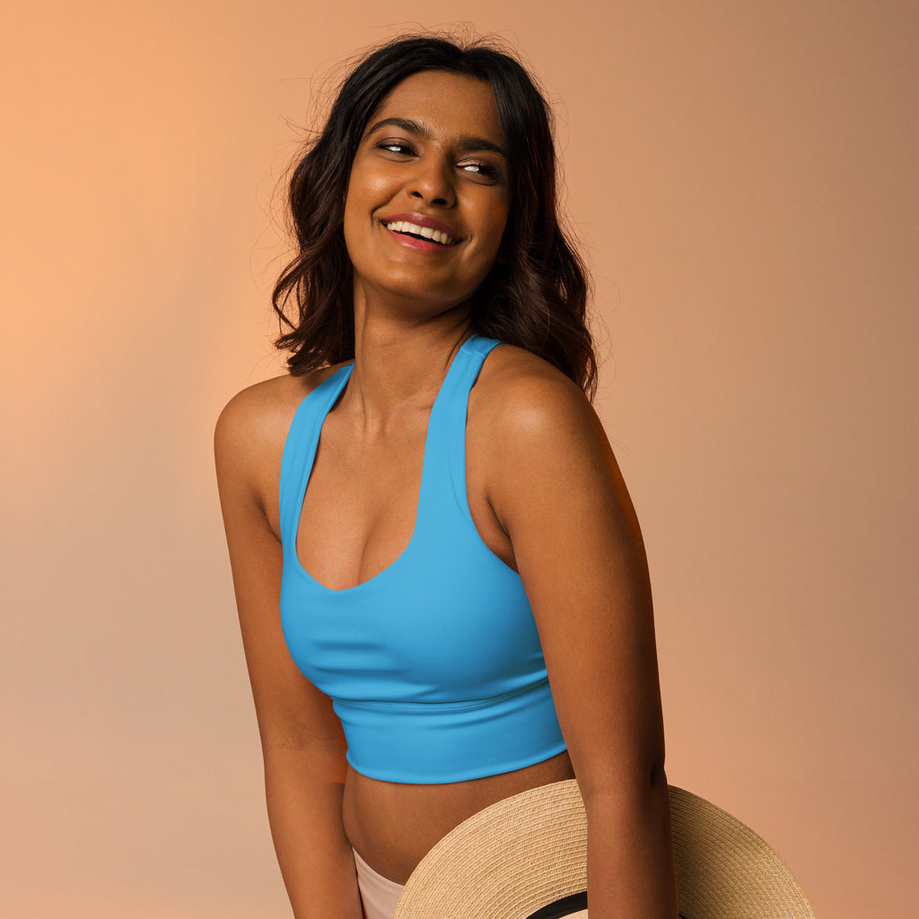 A vibrant blue recycled longline sports bra with deep scoop neckline wide straps and high intensity support