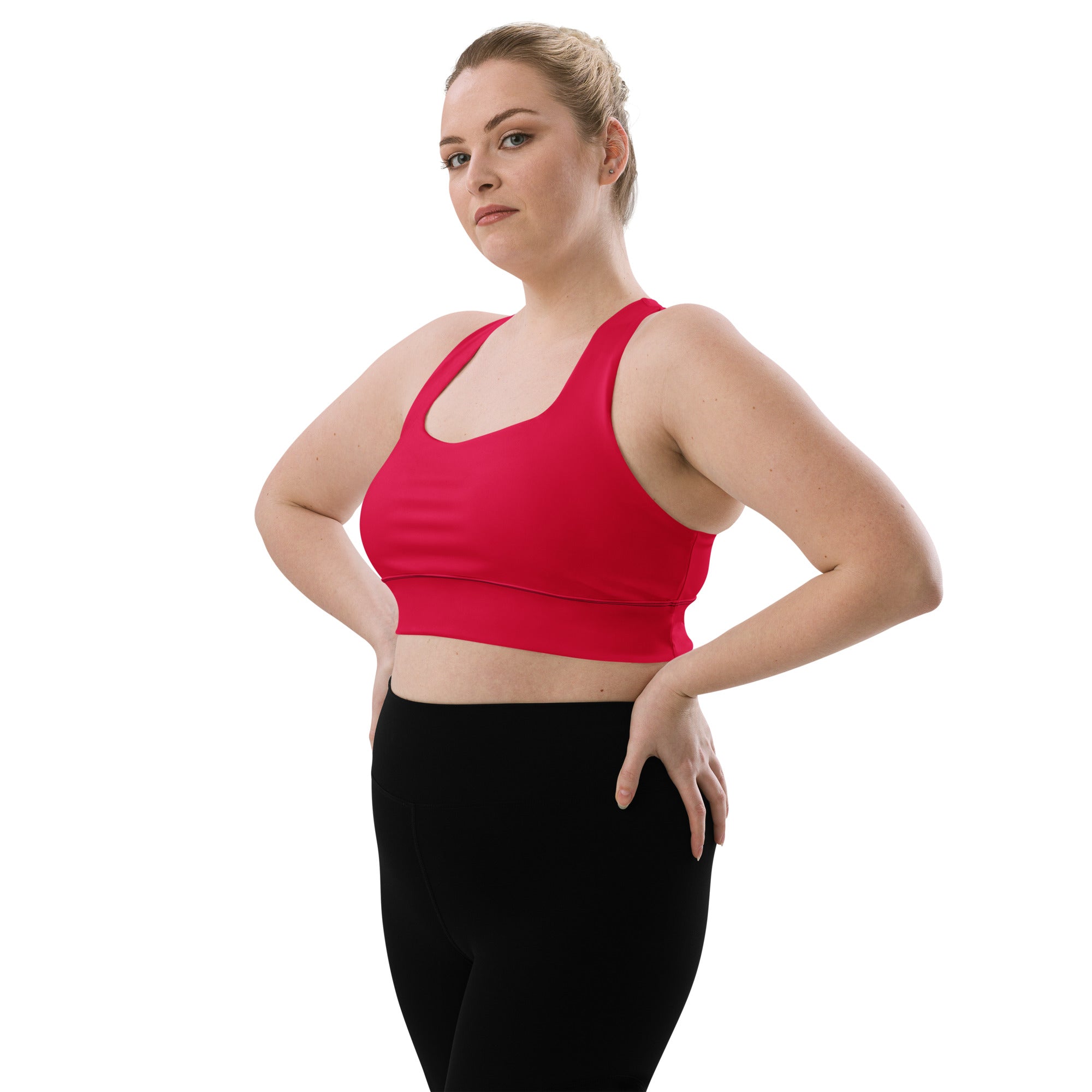 A vibrant red seamless women’s sports bra with scoop neckline wide straps buttery soft recycled fabric high intensity support