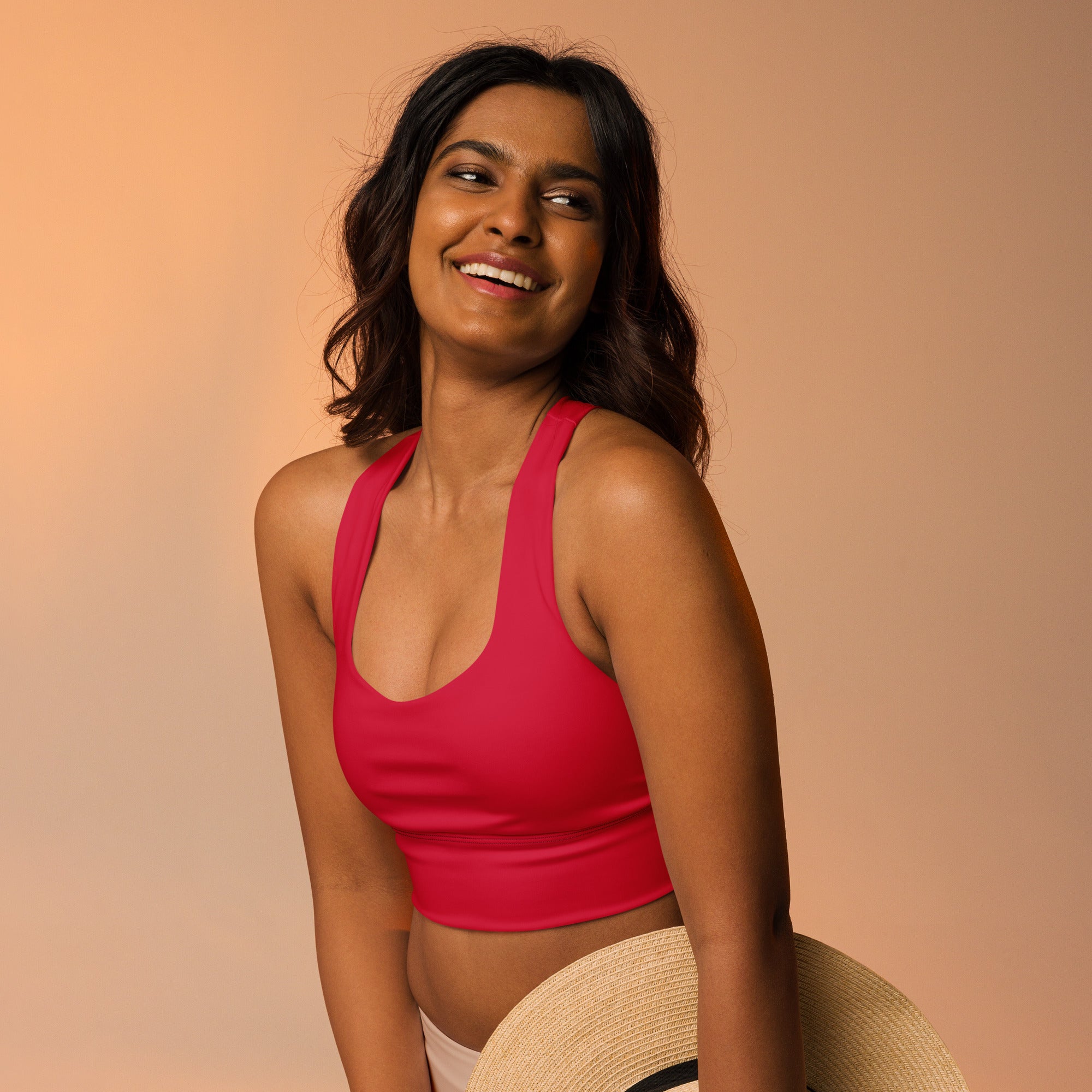 Vibrant red cropped sports bra with thin straps and rounded neckline made from buttery soft recycled fabric for high intensity support