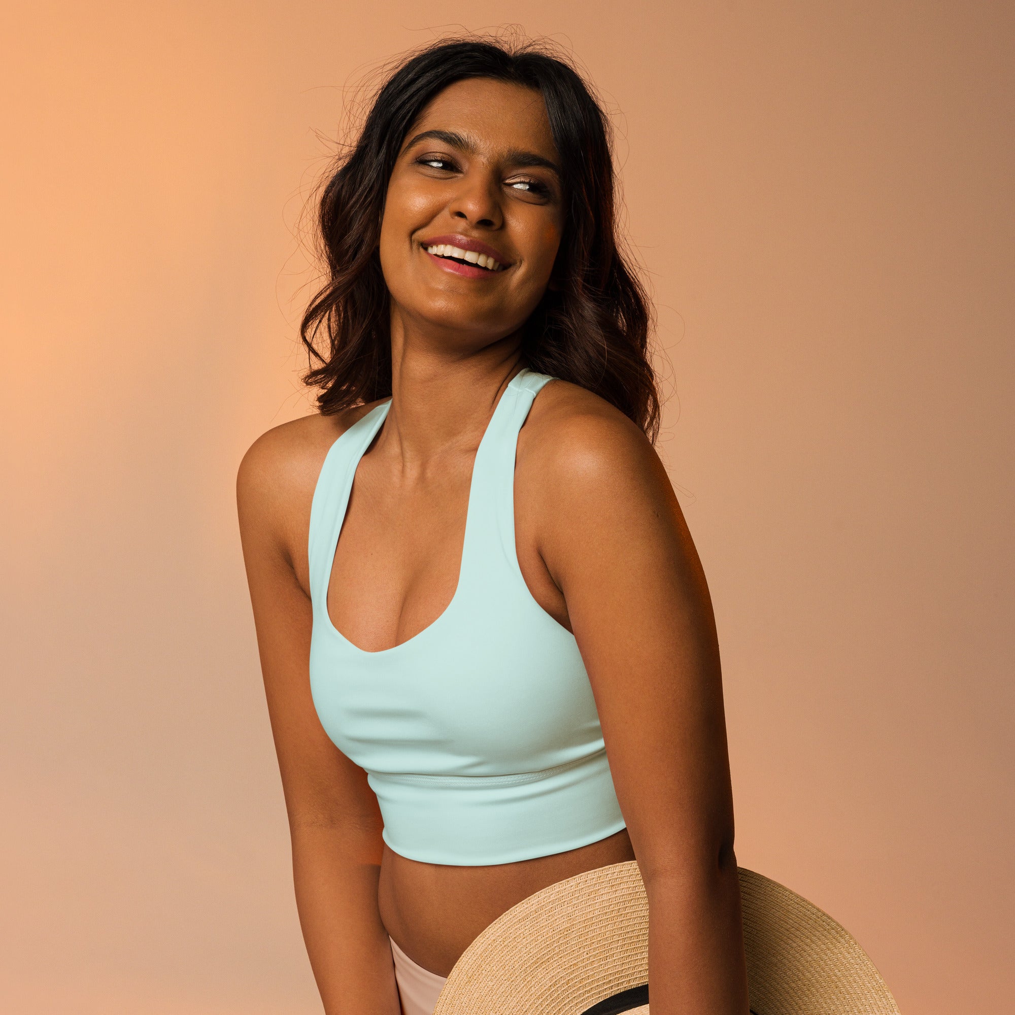 Light blue cropped sports bra with thin straps and rounded neckline made from buttery soft recycled fabric