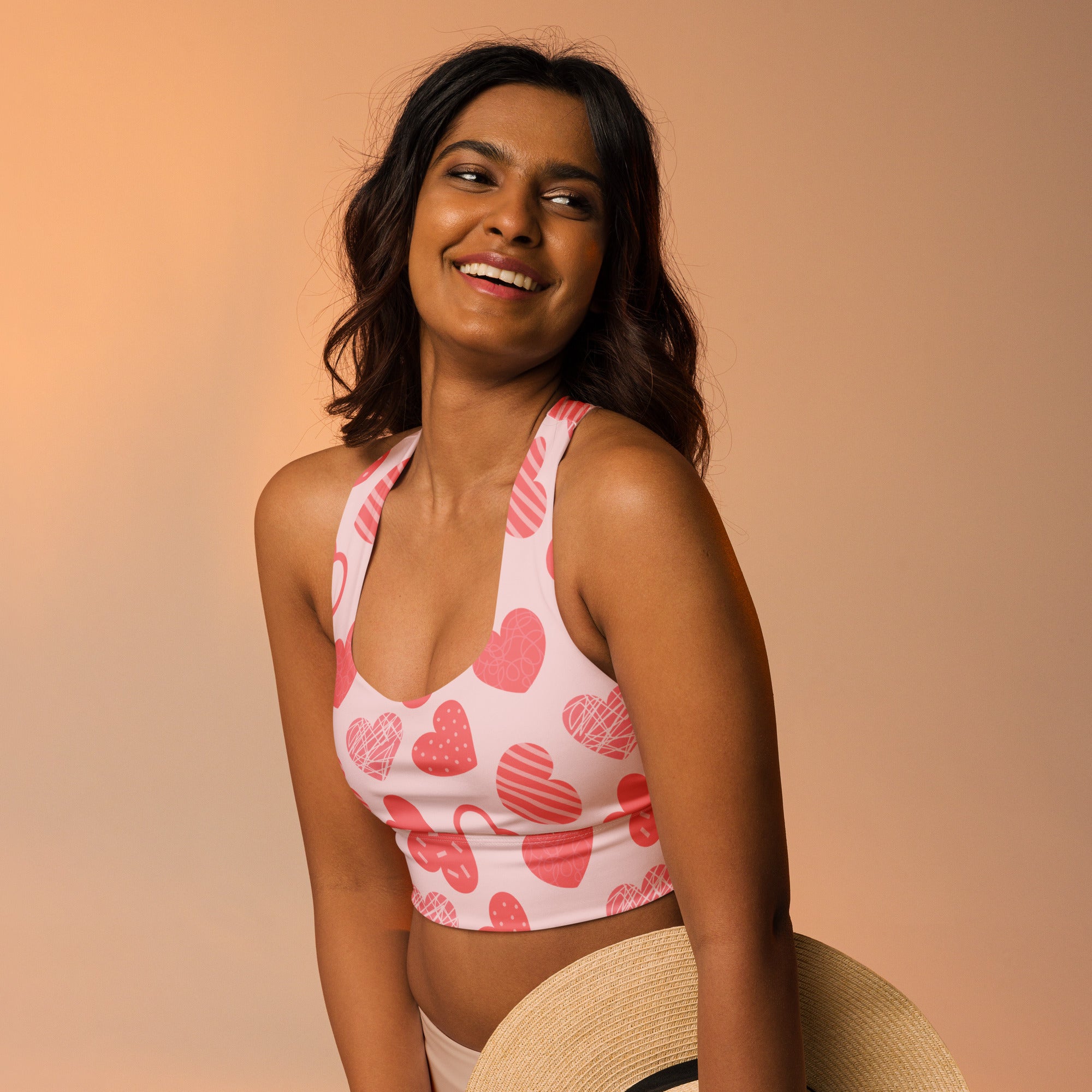 Women’s pink heart pattern buttery soft recycled crop top with halter neck and racerback straps for high support