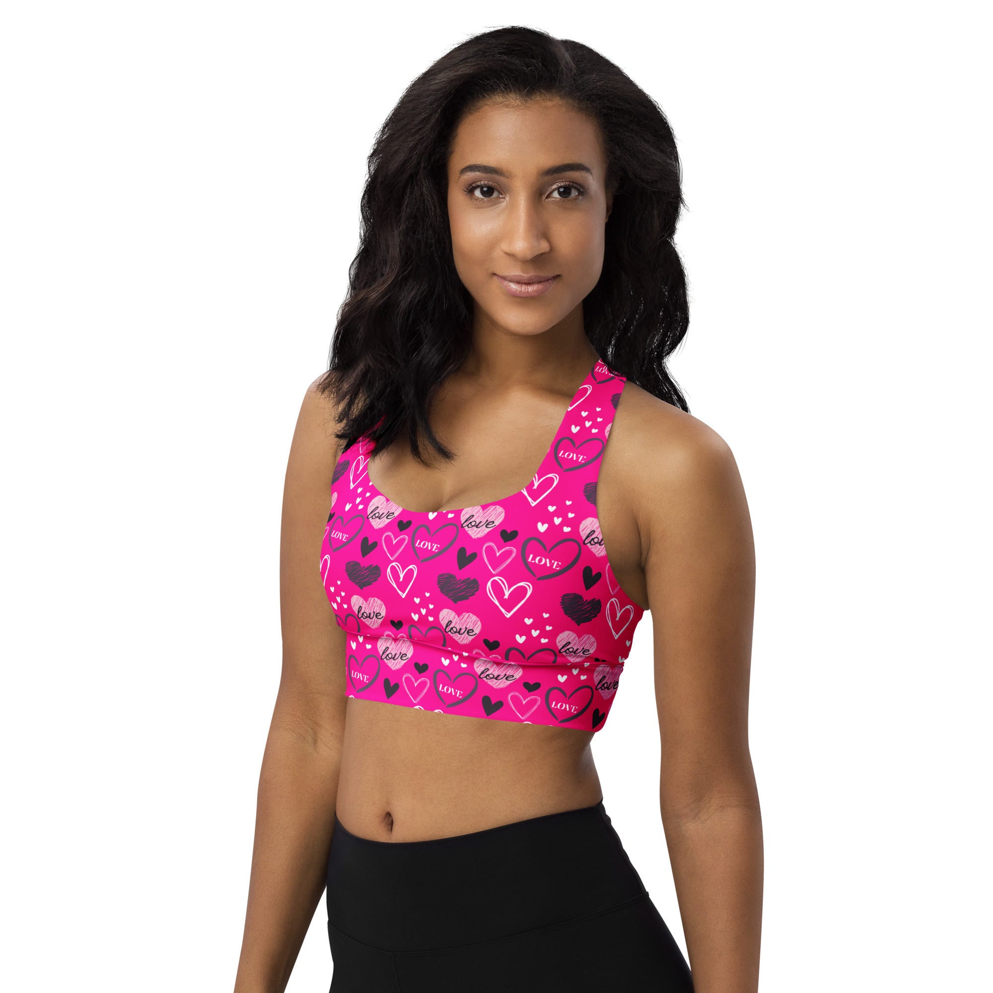 A vibrant pink longline sports bra with love heart pattern made from buttery soft recycled fabric for high intensity support