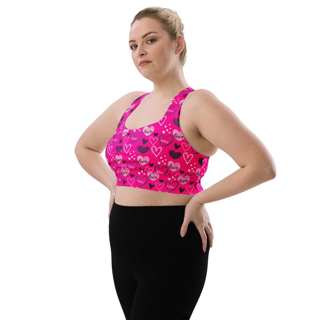 Women’s vibrant pink love heart sports bra with buttery soft recycled fabric high intensity support and quick dry features