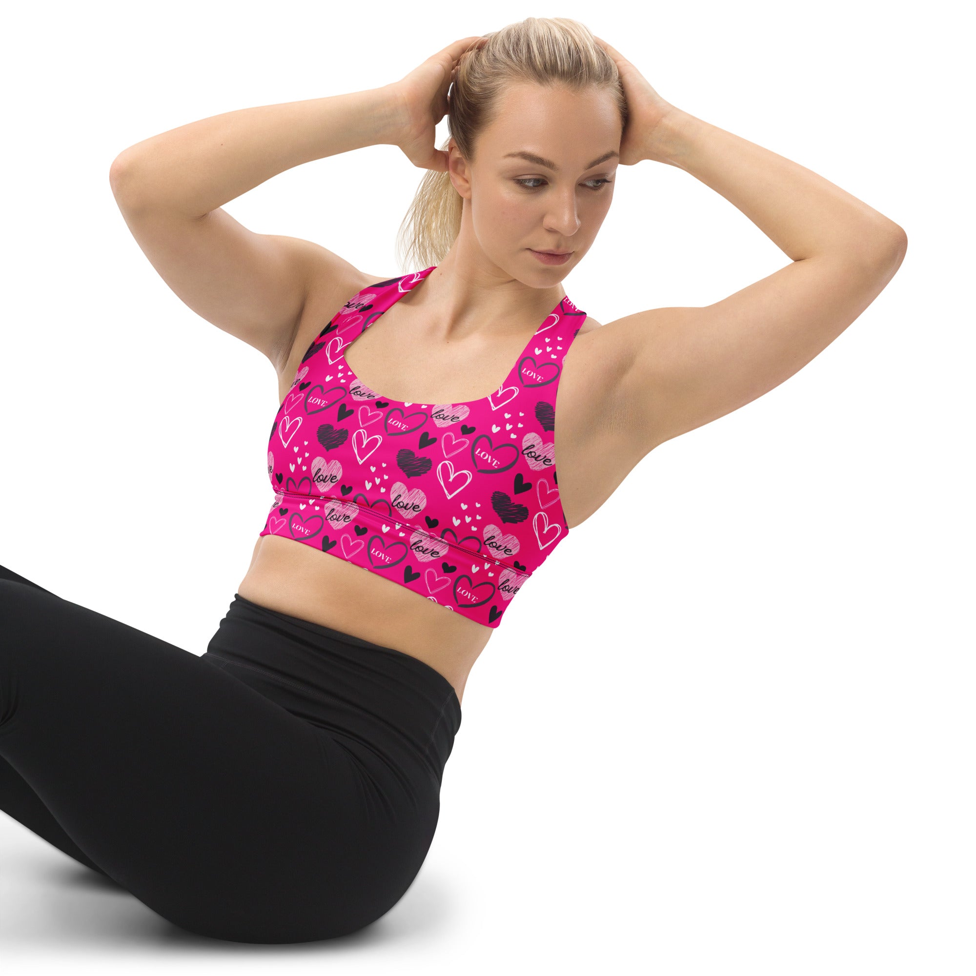 Women’s vibrant pink love heart longline sports bra with buttery soft recycled fabric for high intensity support