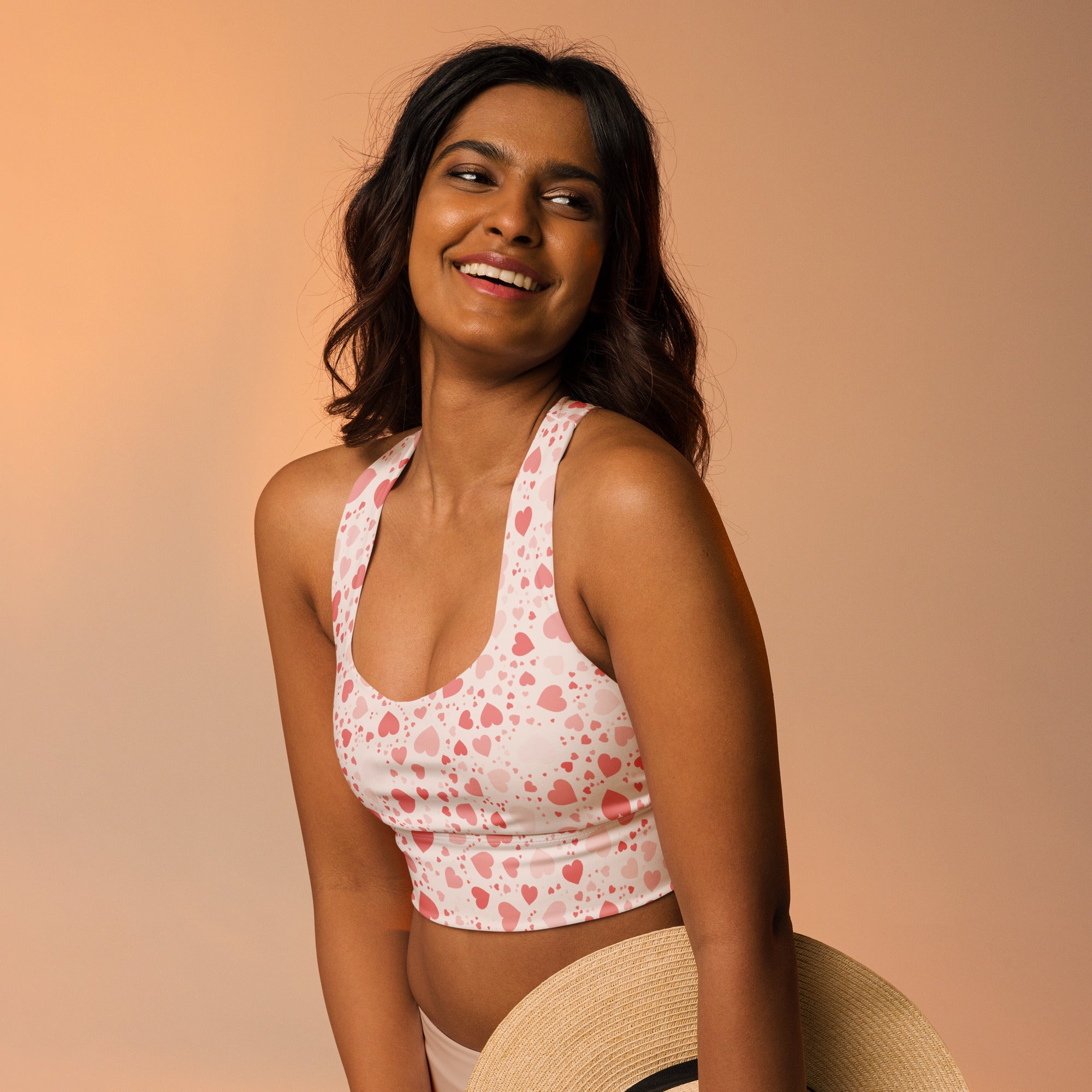 White longline sports bra with pink heart pattern butter soft recycled fabric high intensity support and quick dry