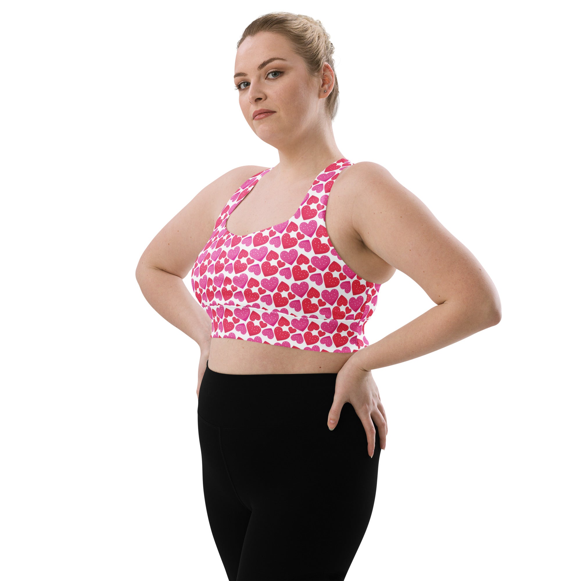 Women’s pink and white heart patterned crop sports bra with high intensity support and buttery soft recycled fabric