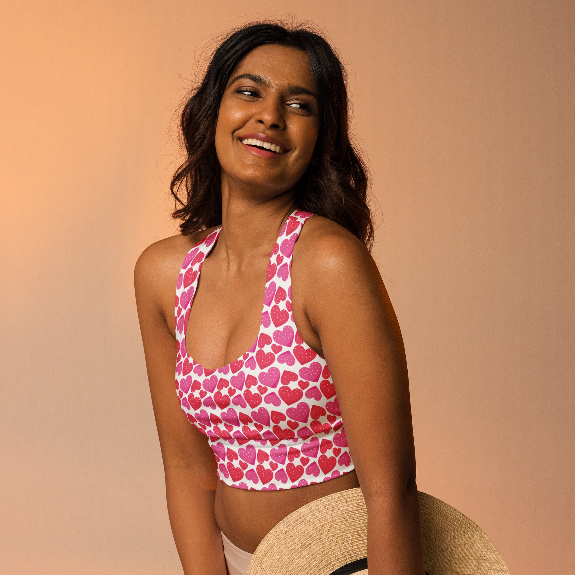 Women’s pink and white heart patterned halter top with cropped fit and buttery soft recycled fabric for high intensity support
